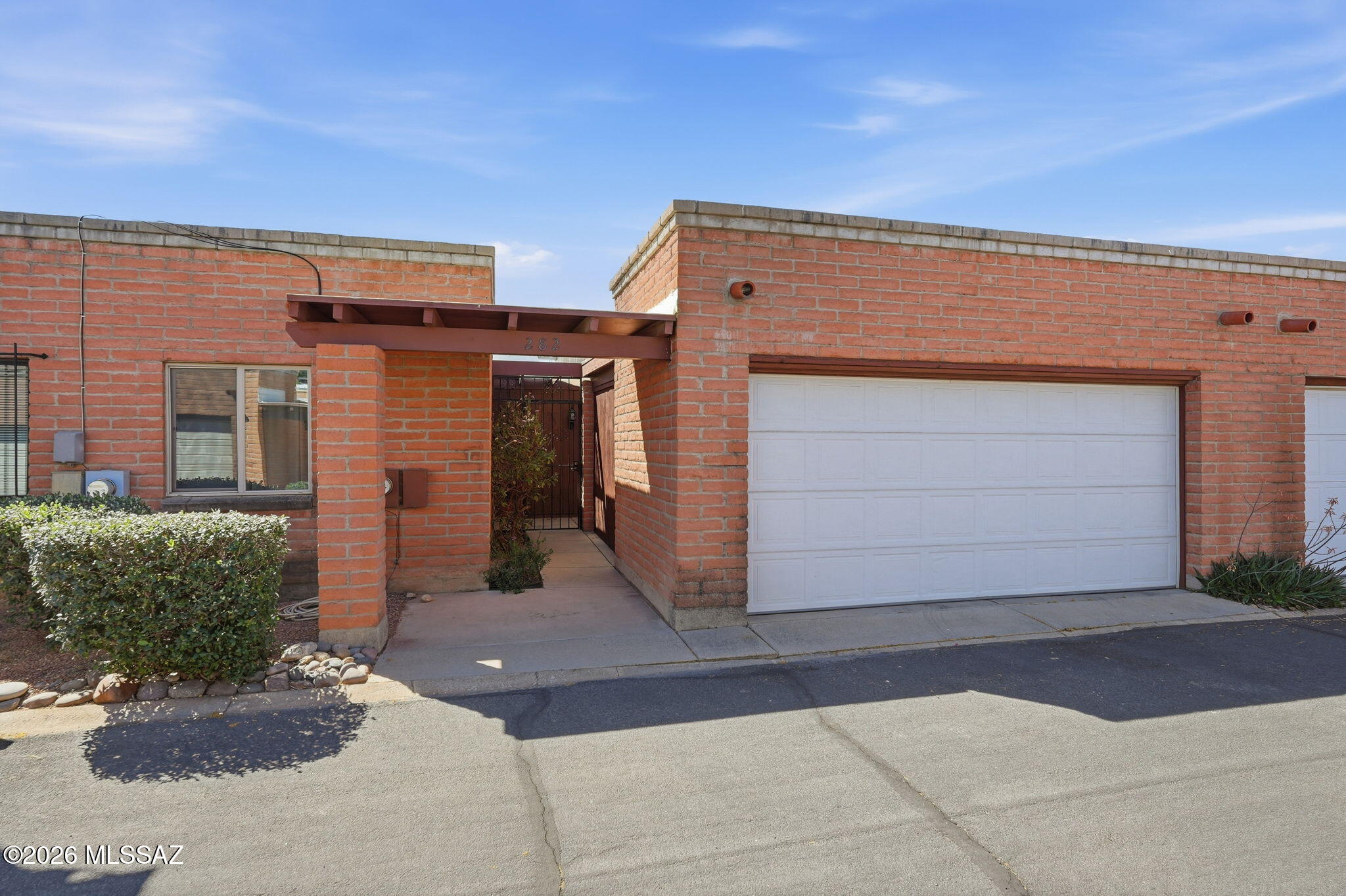 Enjoy easy living in this well-maintained townhome featuring newer flooring, a newer roof, skylights that fill the home with natural light, and security doors for added peace of mind. Solid masonry construction offers lasting quality, while abundant storage and an attached two-car garage provide everyday convenience. Relax on the covered patio, perfect for outdoor enjoyment. The community features a sparkling pool and is ideally located close to shopping and dining, and just a short stroll to Limberlost Family Park with walking paths, a playground, shade and recreation opportunities. Tranquil setting, convenient location; one of Tucson's best kept secrets!