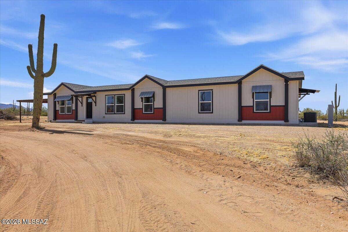 BACK ON THE MARKET AND BETTER THAN EVER!! WITH A PRICE IMPROVEMENT!! Beautiful Country Living on 5 Acres with Stunning Mountain Views! Experience the perfect blend of peaceful desert living and modern convenience in this move-in-ready 4-bedroom, 2-bath home set on 5 flat, usable acres. Located on a paved road with easy access to town, this property is surrounded by breathtaking mountain views and iconic giant saguaros that create a truly authentic Arizona setting. 
Recent exterior upgrades add incredible curb appeal, including a custom steel made two-car carport, a freshly graded U-shaped driveway for easy access and ample parking, and custom steel awnings have been added over the windows and entryways that perfectly complement the home's modern ranch style. The front and side doors have been freshly painted in the home's bold trim color, creating a striking, welcoming entrance. 
The spacious homesite offers endless possibilities. Bring your horses, start a hobby farm, store you RV and toys, or design the outdoor lifestyle you've always dreamed of. The property is RV-ready with a dedicated sub-electrical hookup for added convenience. Enjoy year-round outdoor living under the massive custom-steel covered patio that spans the entire length of the home. Perfect for entertaining, relaxing, and taking in Arizona's spectacular sunsets. 
If you've been searching for wide-open spaces, modern updates, and room to make your vision a reality, THIS IS THE HOME FOR YOU!!