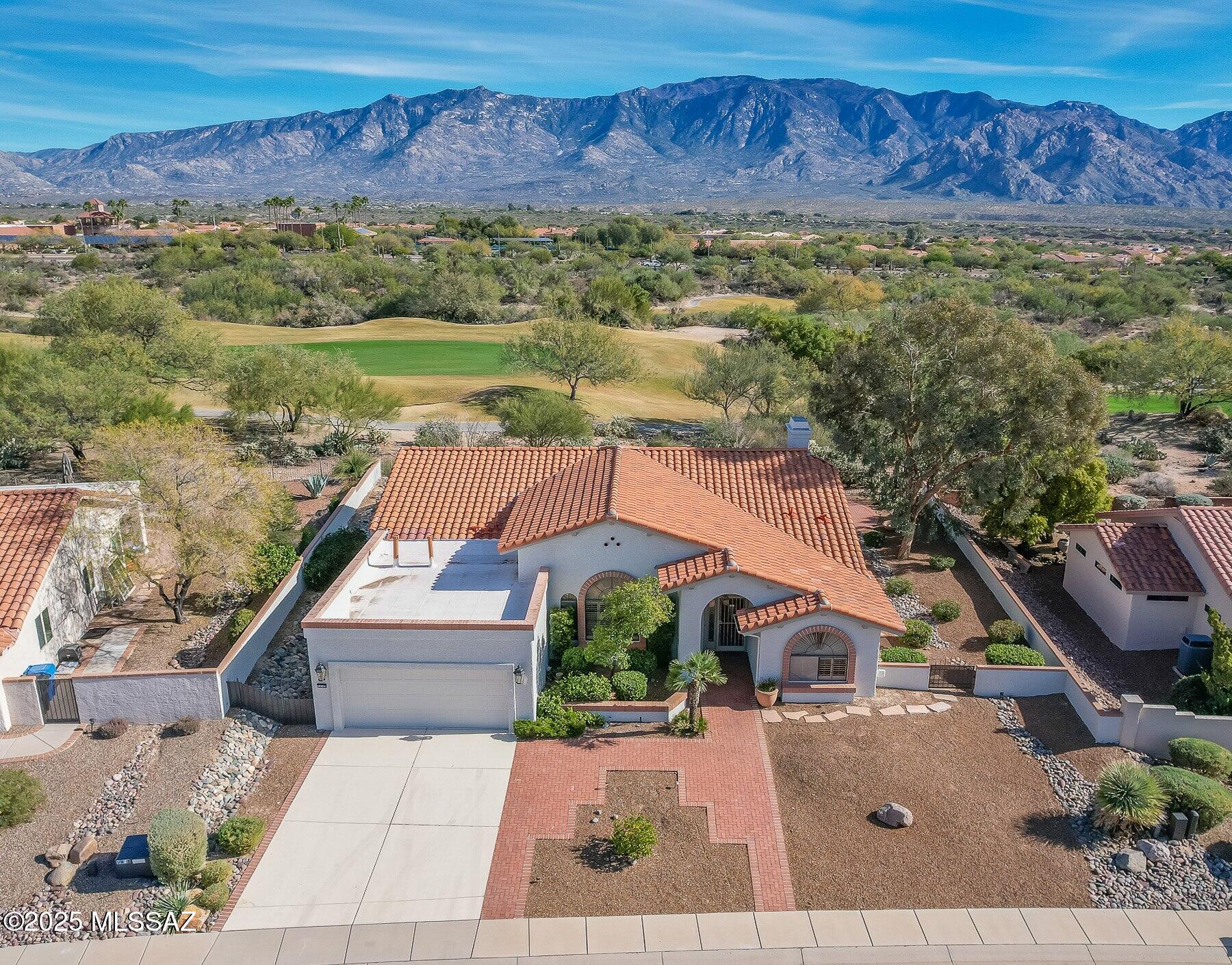 Enjoy an active adult lifestyle in this 3BD/2BA +Den (2,328 sq ft) updated Breckenridge model on large view lot offering spectacular golf course and Catalina mountain views from inside & out. Soaring ceilings greet you in the expansive formal living/dining room with tall arched window and plantation shutters. Adjacent lies a den/office with wraparound bookshelves and desk. Relax in the spacious Great room with built-in bookshelves and cozy gas fireplace. Gourmet kitchen hosts center island, updated countertops and new cabinets, stainless appliances with gas cooktop & wall ovens, plus dining nook with workstation. Owner's suite with bay window offers a dual sink vanity, walk-in shower and step-in jetted tub, plus large walk-in closet. Main guest room features arched window. Additional updates include diagonal set tile, plush carpeted bedrooms and interior paint. Laundry with utility sink, extended garage with workbench plus zoned HVAC. Step outdoors and enjoy the extended rear covered patio, lush landscaping, extensive brick pavers, plus panoramic mountain & golf course views.