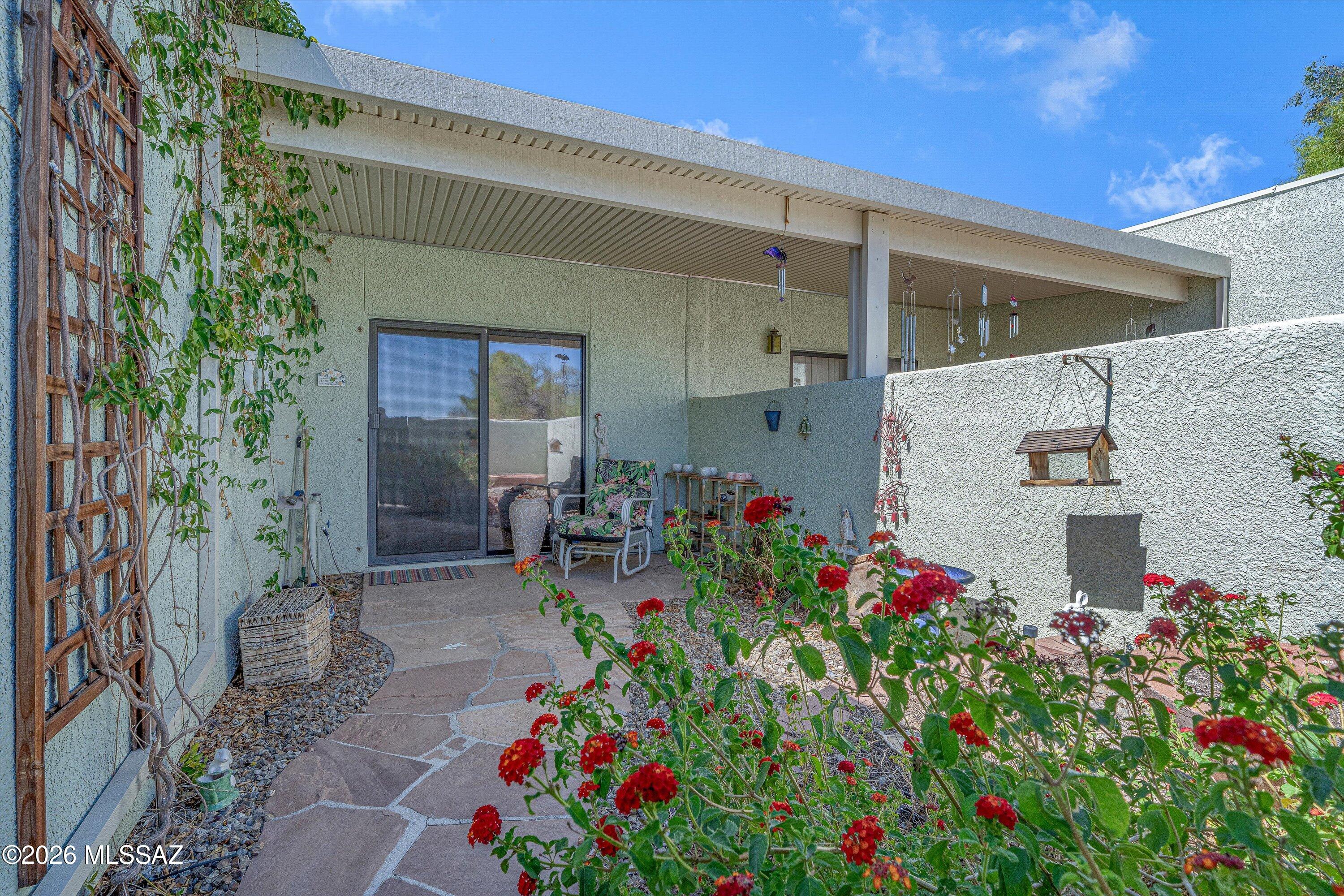 Tucked inside a gated 28-unit community near Oro Valley, this beautifully updated one-story 2BR/2BA townhome was finished and staged with a level of attention that shows in every room. Custom cabinetry, granite countertops, skylights, split bedroom plan, walk-in closets, and a new HVAC (2023). The 2-car attached garage with direct interior access is rare for the community. No interior steps. Cute covered private patio for your private garden. Low-maintenance living in a secure, beautifully landscaped enclave with mature trees and fountains. . The HOA handles the exterior, a sparkling community pool, spa, and shaded ramada. For the buyer who wants less to manage and more to enjoy whether that's year-round or seasonally this one delivers.