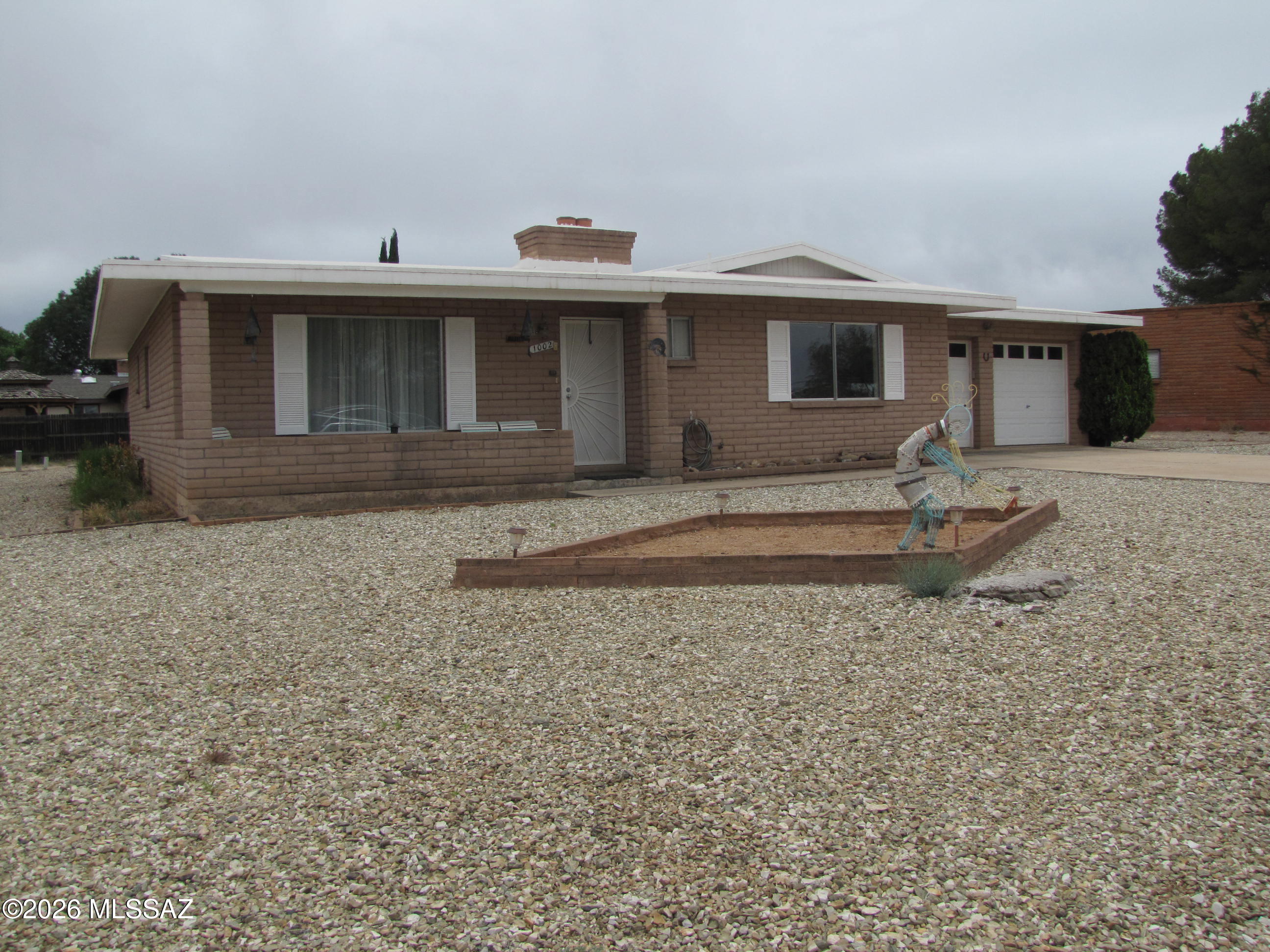 Well maintained 4BR/2Ba home in Sunsites  with view of local vineyard and the Dragoon Mtns. Living room + family room with wood burning fireplace (could be used as dining room). Split bedroom plan. MBa has step-in shower. Pantry and breakfast bar in kitchen along with dining area.  Arizona room with lots of natural light just off the kitchen & family room. Next to AZ room is workshop with workbench, cabinets and a skylight. Two-car garage with separate garage doors, laundry closet, fold-up laundry table, cabinets and shelves. Doors from garage into kitchen and workshop. Alley at the rear of the property. Located close to the amenities in Sunsites, with easy access to Hwy 191 and I-10.
