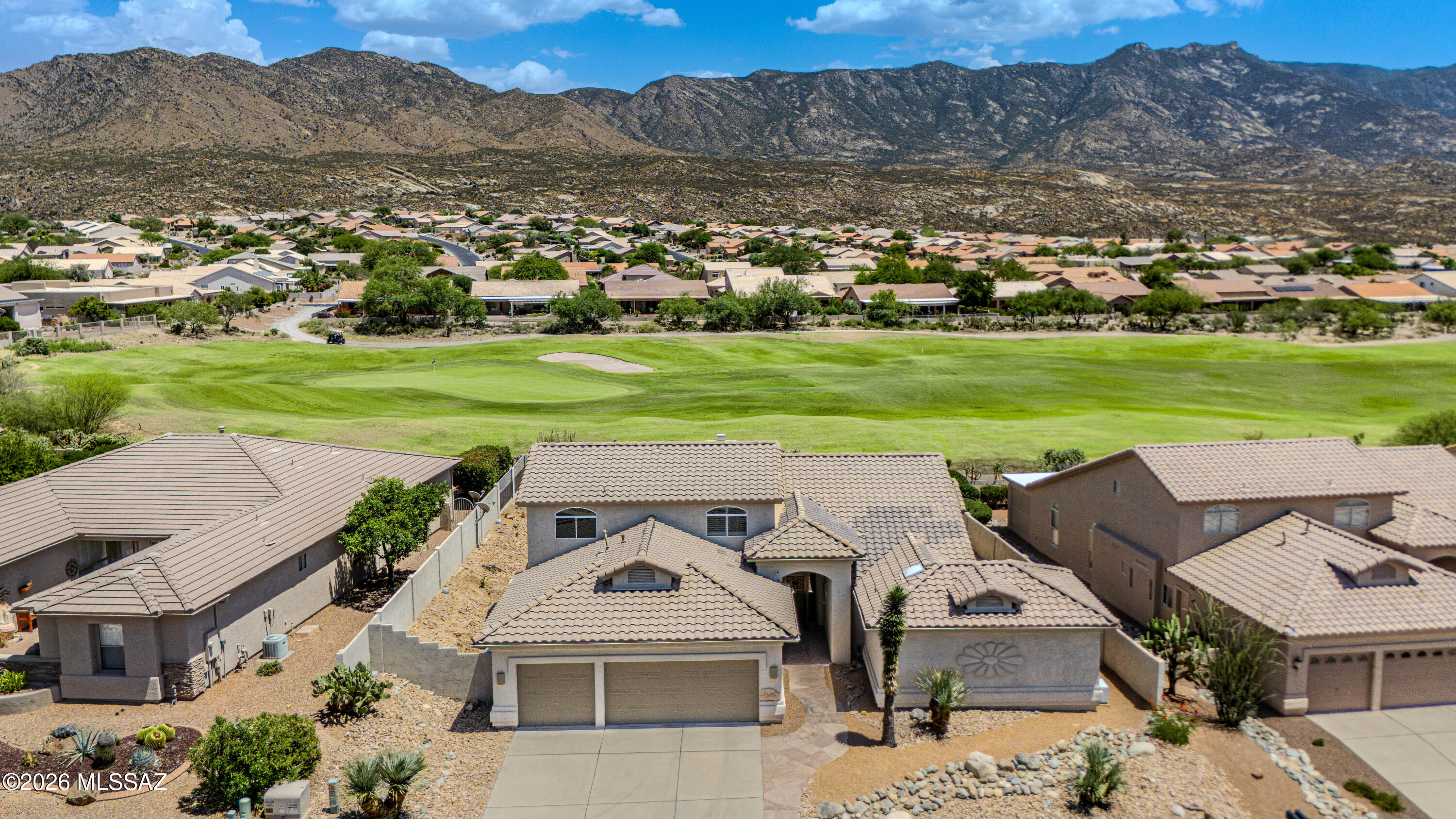 Enjoy resort-style living in this beautifully maintained 3,525 sq ft home overlooking the first green from an elevated lot, minimizing stray golf ball concerns while offering panoramic golf course, mountain, and sunrise views. The flexible floor plan features a den, multiple living and dining areas, soaring ceilings, skylights, high-end appliances, abundant storage, and a 3-car garage. Recent updates include a new roof, exterior paint, and covered patio. The spacious primary suite and private main-level guest suite with full bath and separate entrance are ideal for guests or multigenerational living. Enjoy SaddleBrooke's premier amenities, including golf, pickleball, tennis, fitness centers, pools, restaurants, clubs, and endless activities.