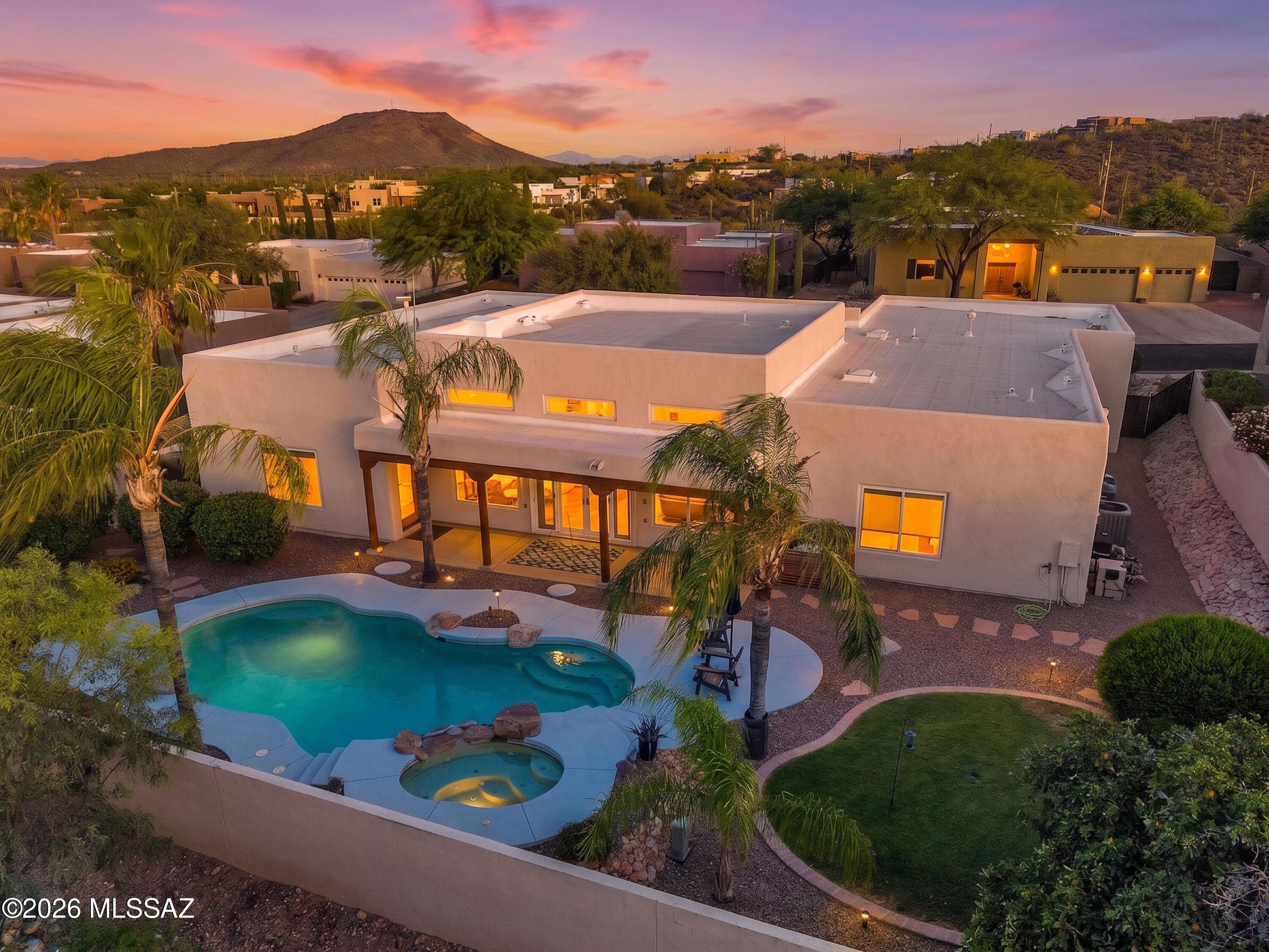 Luxury desert living in the Tucson Mountains with Catalina views and stunning upgrades throughout. Enter through a tranquil courtyard into a light filled home with soaring ceilings, four spacious bedrooms, and beautifully remodeled baths. The custom chef's kitchen features marble countertops, extensive cabinetry, oversized double ovens, stainless farmhouse sink, and a dramatic marble island with seating for four. New rear doors and windows enhance the indoor/outdoor connection and frame the resort style backyard with pool, spa, and multiple entertaining spaces. Enjoy Tucson's renowned dark skies and mountain views from your private oasis. Additional updates include newer HVAC systems, water heaters, pool equipment, and more. See the upgrade list in Documents.