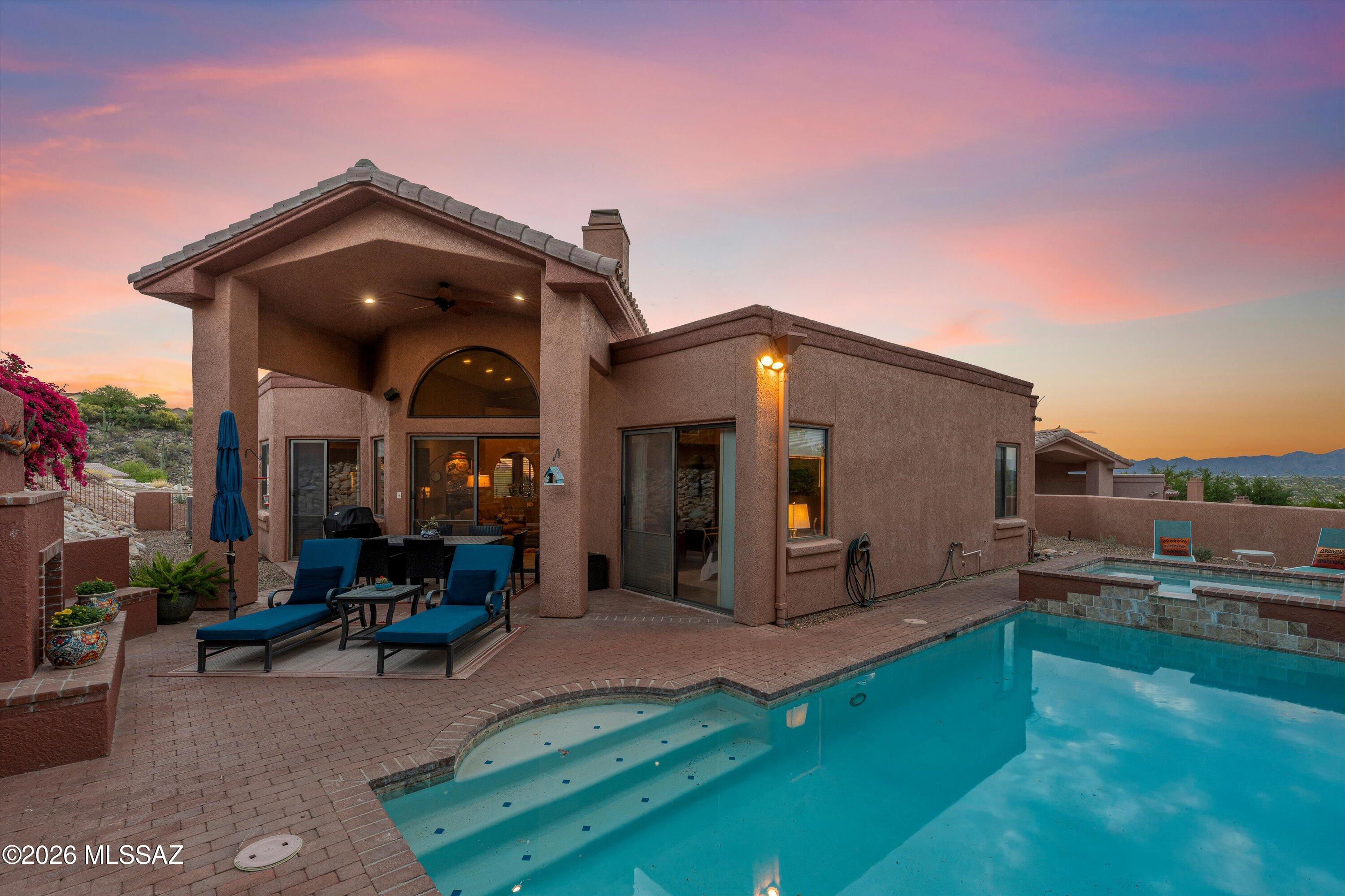 Reach out and touch the mountain views from this welcoming 3-bedroom, 2-bath residence located in the sought-after guard-gated community of La Reserve. As you enter, clerestory windows frame the stunning Pusch Ridge peaks, filling the home with natural light and breathtaking scenery. The open-concept great room features soaring ceilings and flows seamlessly into the updated kitchen, complete with granite countertops, double oven, and stainless-steel appliances. A formal dining room provides an elegant space for hosting family and friends. Step through the 8-foot sliding glass doors to an inviting outdoor entertaining area showcasing a built-in fireplace, and a beautifully refinished pool and spa. A tranquil, Zen-inspired seating area just up a few flagstone steps offer the perfect place to relax and take in the views. Enjoy Meyers lemons and oranges fresh from your trees.. Spanning 2,025 square feet, the one story home includes a spacious primary suite with 8-foot sliders leading to the backyard. The updated primary bath features dual vanities, a separate shower, and a soaking tub for ultimate comfort. The 2 additional bedrooms provide flexibility for guests as bedrooms, a home office, or den. Conveniently located near dining, shopping, golf, and hiking, this exceptional property offers the perfect blend of comfort, style, and Arizona living at its finest.