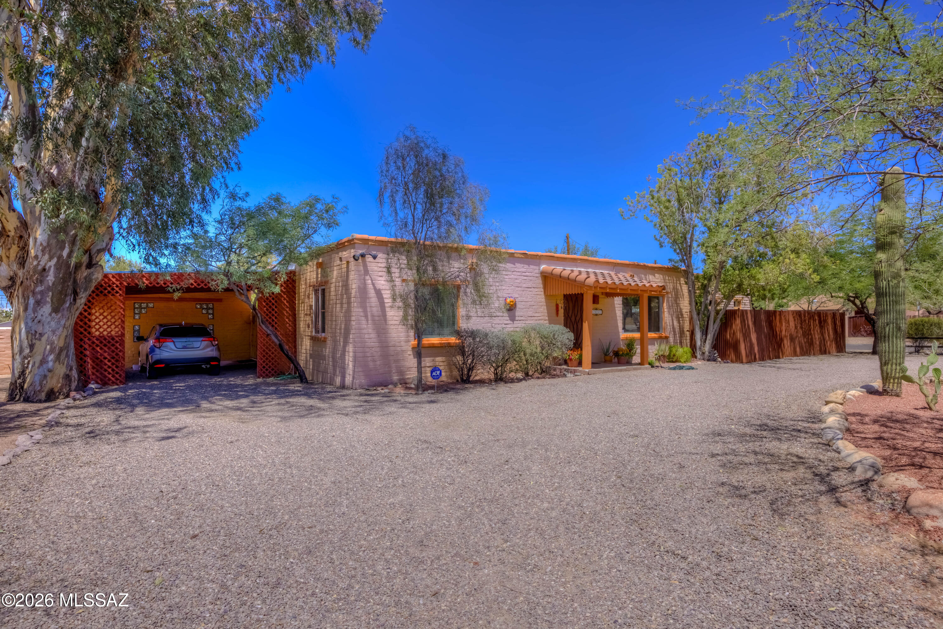 Charming Territorial Style Home With Mountain Views! 2BR/2BA Main Home plus Separate 1BR/1BA Guest Casita. Home features separate Living Room, Family Room with cozy fireplace, saltillo tile & stained concrete floors, stylish southwest-style bathrooms, solid slump block construction, newer AC system, and much more. Bright kitchen with Talavera tile counters, rich wood cabinets, and gas cooking. Breakfast area with mountain views. Interior laundry room includes washer & dryer. Separate Guest Casita with full bathroom and French sliding doors overlooking the backyard. Covered back patio, beautiful natural landscaping, drip & passive rainwater irrigation, fully wallled yard with mountain views. Convenient location near Campbell corridor shopping & dining - only a short bike ride to the U of A!