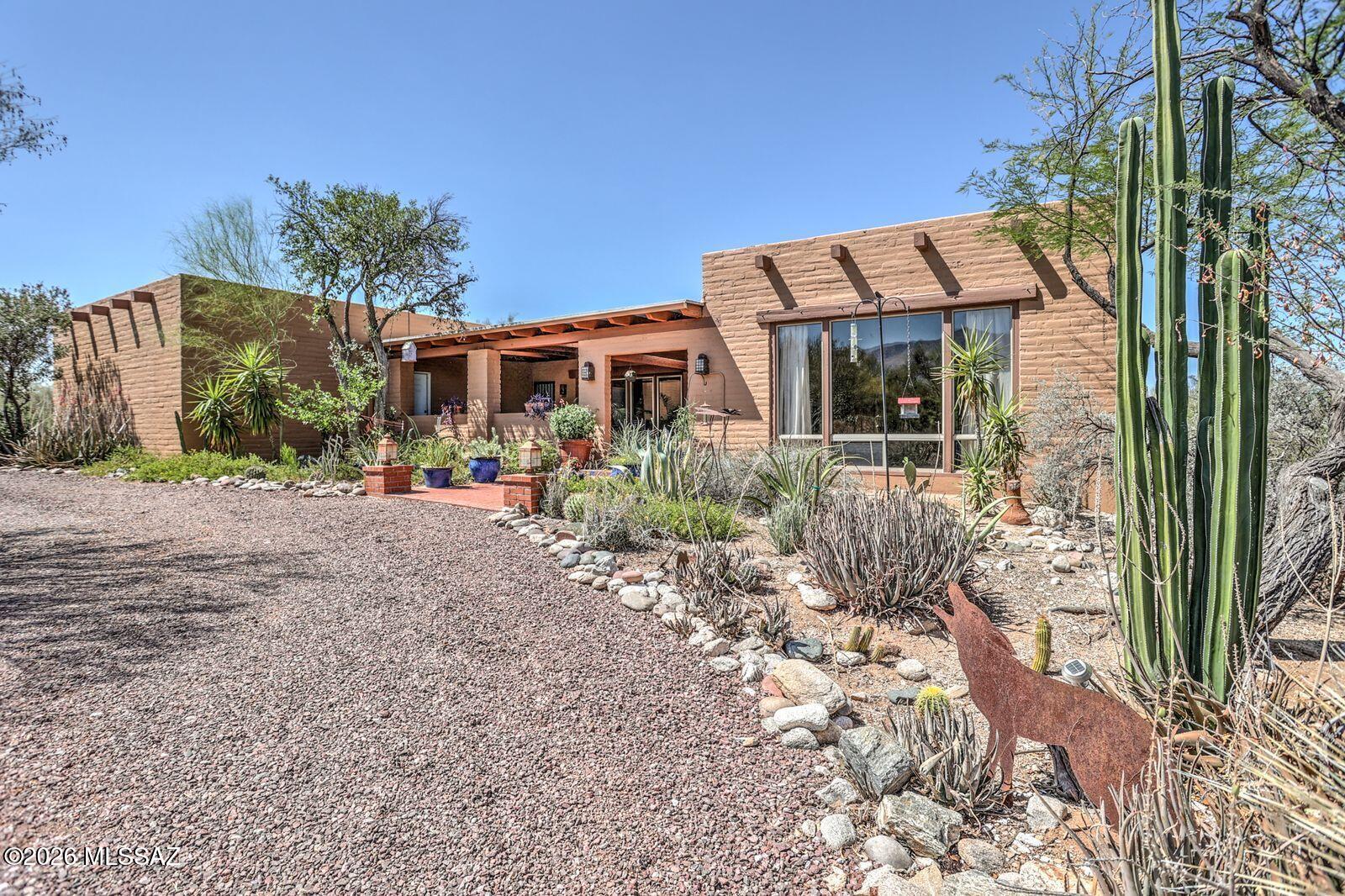 Welcome to Catalina Foothills Estates 7! This Santa Fe home offers a spacious great room w/ stunning mountain views, beehive fireplace, formal dining area & opens to a private patio. The large covered front patio is an entertainers delight. Its design not only enhances outdoor enjoyment but also frames stunning views of the Catalinas, creating a picturesque backdrop for memorable moments w/ family & friends. Kitchen is off the family room, featuring a 2nd fireplace & large 2nd patio area w/ city views, A Mountain & Tumamoc. Charming 2304 ft.² home features 3 bed/2.5 baths, exuding a warm Southwestern vibe. Enjoy spacious living areas, vibrant decor & cozy atmosphere. Set on a spacious 1-acre lot & offers a private retreat to enjoy the tranquil beauty of the Tucson desert. Dual zoned HVAC system installed in the last 4-5 years. 
New water heater in 2024. 
Home exterior freshly painted.