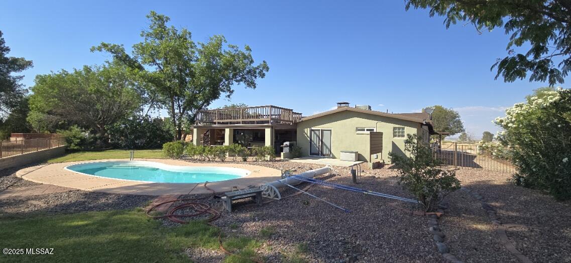 Welcome to this stunning 5-bedroom, 4-bathroom home nestled in the peaceful and scenic rural community of Pearce.  Perfectly situated with breathtaking views of Cochise Stronghold, this property offers a serene retreat with modern upgrades and outdoor living spaces designed for relaxation and entertainment.
Enjoy Arizona sunset evenings  by the sparkling pool or hosting gatherings at the outdoor kitchen and expansive view deck—ideal for taking in the starry, dark night skies that make this area truly special. The home features a new roof, gutters with leaf guard, and many other upgrades including all kitchen appliances ensuring both beauty and functionality.