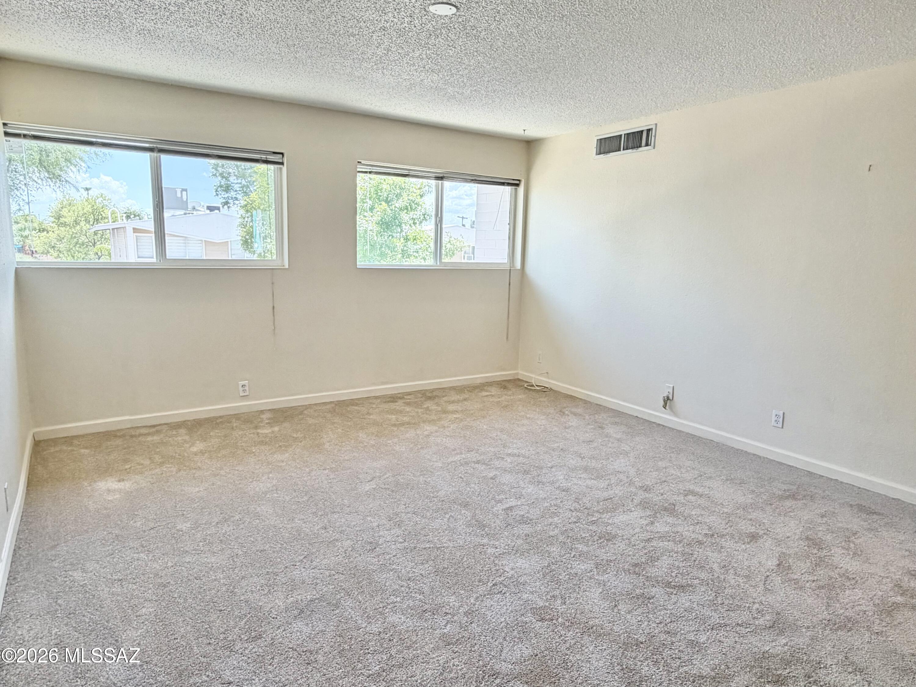 End unit with no neighbors on four sides. Dual pane Low-E windows, new carpet, newer A/C (2023), updated kitchen with maple cabinets. Refrigerator included. Easy access to the community pool. HOA fees cover property taxes, water, sewer, trash, roof maintenance, pest control, exterior maintenance, pool, water heaters, and more. Convenient location to restaurants, shopping, bus lines, and Reid Park. Cash only, no rentals.