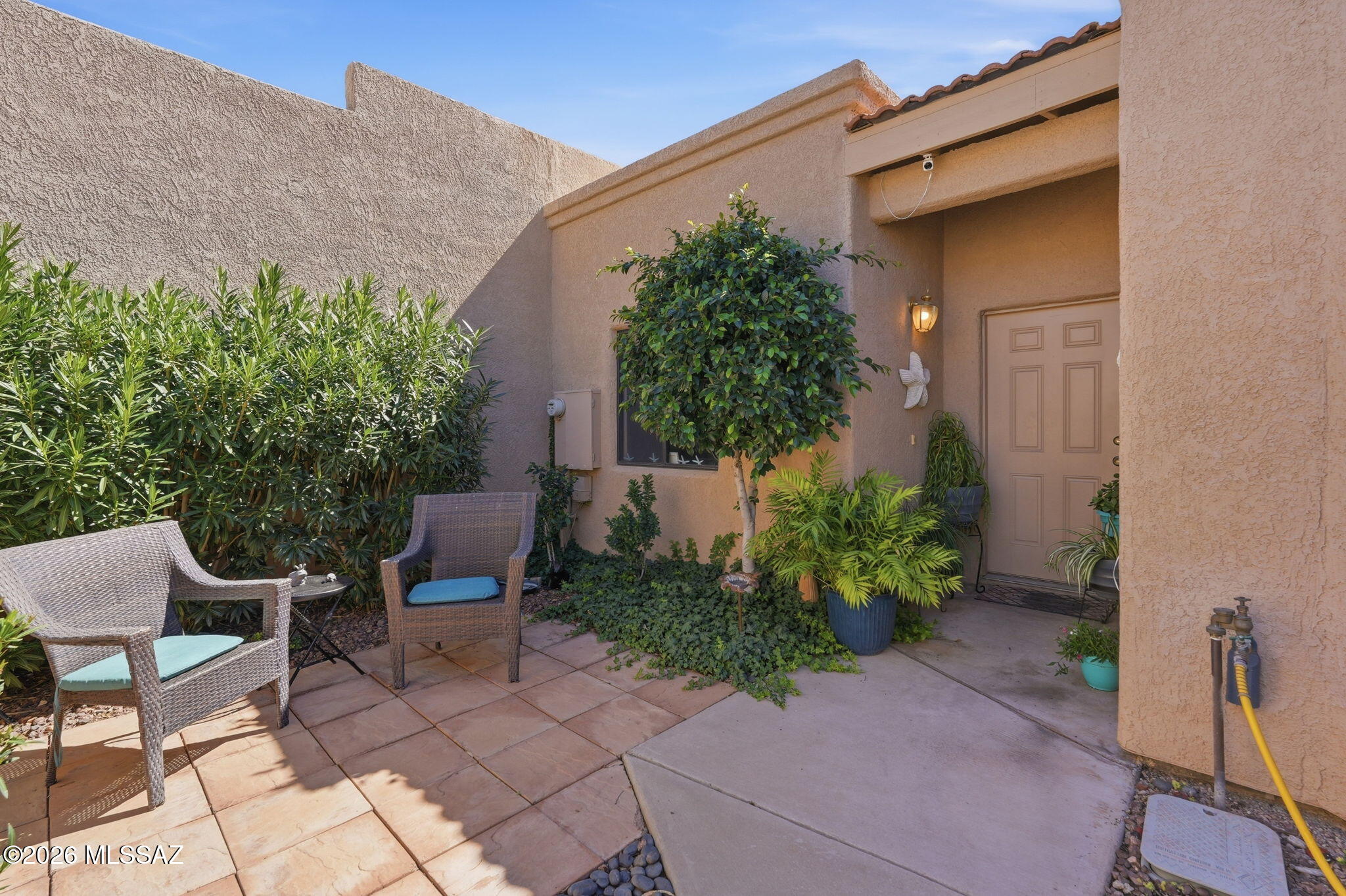 Welcome to this beautifully cared for 2 bedroom 2 bathroom 2 car garage Le Mirador townhouse where soft Southwestern charm meets easy low maintenance living. A bright great room with cathedral ceilings creates an airy uplifting feel that flows into a cozy breakfast nook and inviting kitchen. Split bedrooms offer peaceful separation while tile and plush carpet add comfort underfoot. Step outside to a serene courtyard and a private rear yard with artificial turf flower beds and mature greenery that create an intimate retreat for morning coffee or sunset unwinding. With HOA included water sewer garbage and common area care this home blends simplicity with quiet elegance. Close to shopping parks restaurants and more.