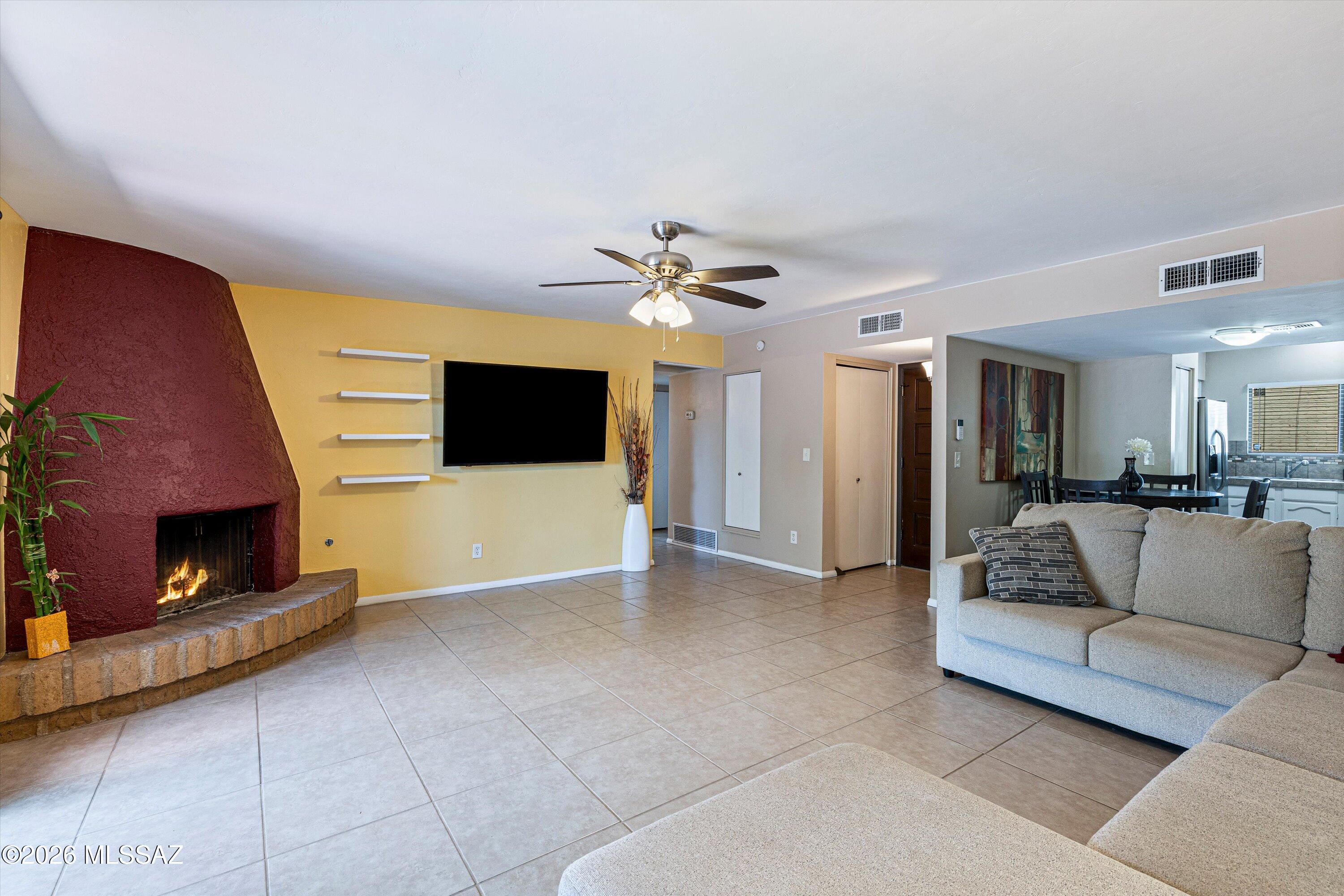Immaculately maintained and move-in ready, This charming 2-bedroom, 2-bath townhome offers the perfect blend of comfort, style, and easy living. Tile flooring and a classic beehive fireplace create an inviting ambiance. The well-appointed eat-in kitchen features stainless steel appliances, a pantry, tile countertops, and a decorative backsplash. The spacious primary suite includes dual closets and a private bath, while the guest bedroom offers plush carpeting and ample storage. Step outside to your own private desert retreat with a covered patio, authentic Saltillo tile pavers, and an above-ground spa--ideal for relaxing under Arizona's beautiful skies. This home is located in a desirable community with a sparkling pool. Newer foam roof installed 11/2024 with a transferable 10 yr warranty.