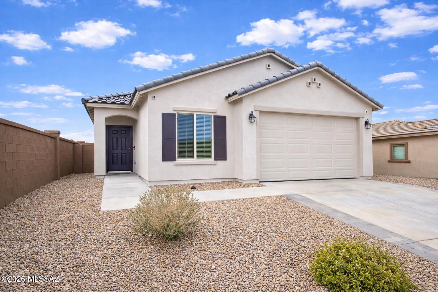 PRICED JUST REDUCED! Beautiful home located in the popular community of Rancho Sahuarita with community pools, splash pad, clubhouse, exercise facilities, parks, trails & much more! This home has 3 bedrooms, 2 bathrooms & 2 car garage with epoxy finished floor making it durable and easy to clean. Spacious kitchen with plenty of cabinet space, elegant quartz counter tops, breakfast bar & stainless-steel appliances. Modern tile flooring in all the right places. Primary bathroom with dual sinks, walk-in closet & walk-in shower.  Spacious laundry room & nice large backyard with covered patio, pavers & artificial grass great for entertaining. Enjoy all the benefits Rancho Sahuarita has to offer! Located close to I-19, restaurants, shopping, schools, hospital and much more! Call Agent for more details or to schedule a showing.