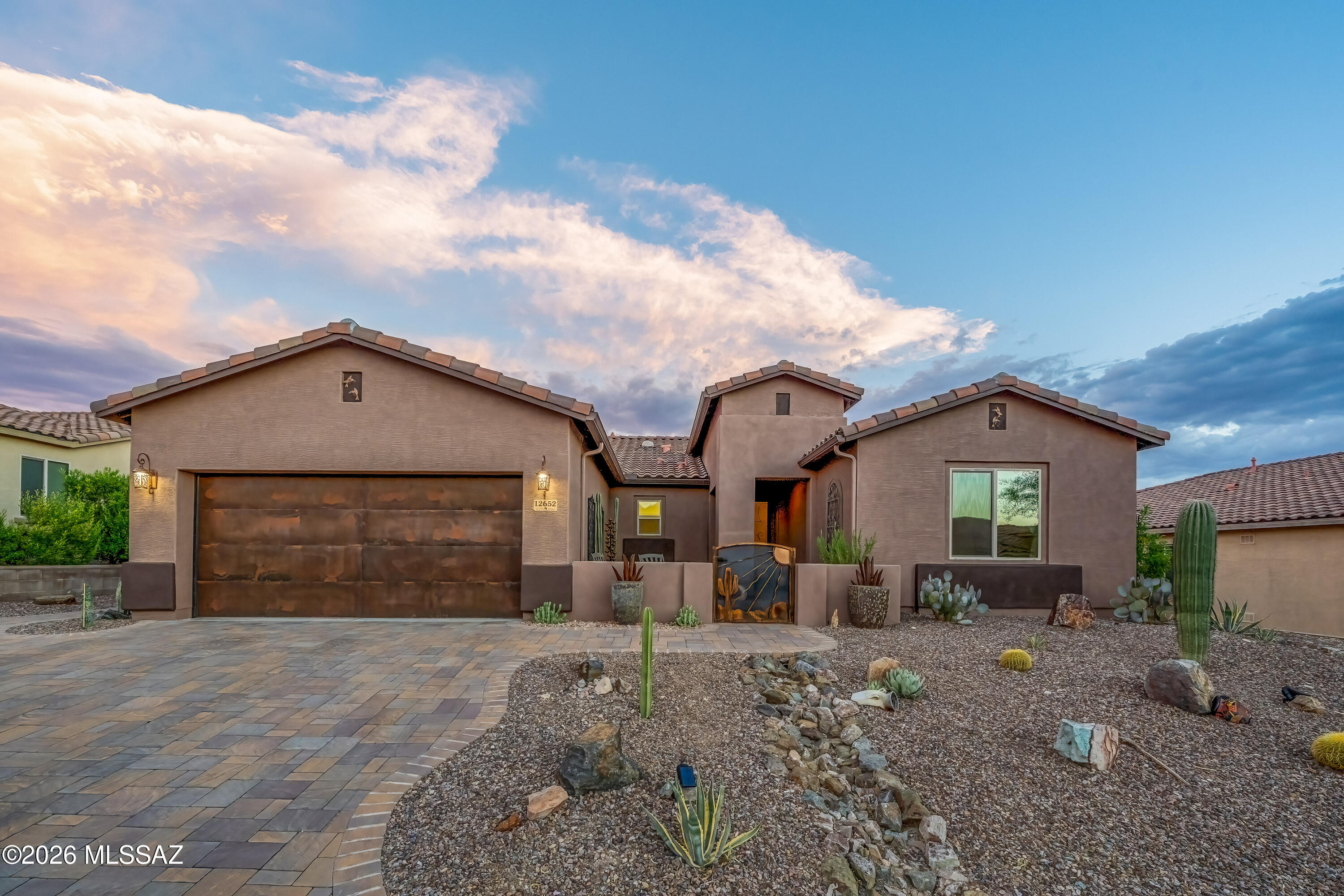 Welcome to Dove Mountain Preserve! This beautifully maintained 3-bedroom, 2-bath home with a den offers an open, split-bedroom floor plan filled with natural light, high ceilings, and tile throughout. The kitchen features maple cabinets, granite countertops, and opens seamlessly to the living area with remote-controlled shades. The versatile den includes its own sliding glass door, making it ideal for a home office, guest suite, or future multigenerational living. Enjoy your private backyard oasis with a saltwater pool, spa, remote-controlled patio shade, Tuff Shed for extra storage, and breathtaking desert views with no rear neighbors. Additional features include fresh interior and exterior paint (2025), a wet bar, laundry room, water softener, and an epoxy-coated garage.