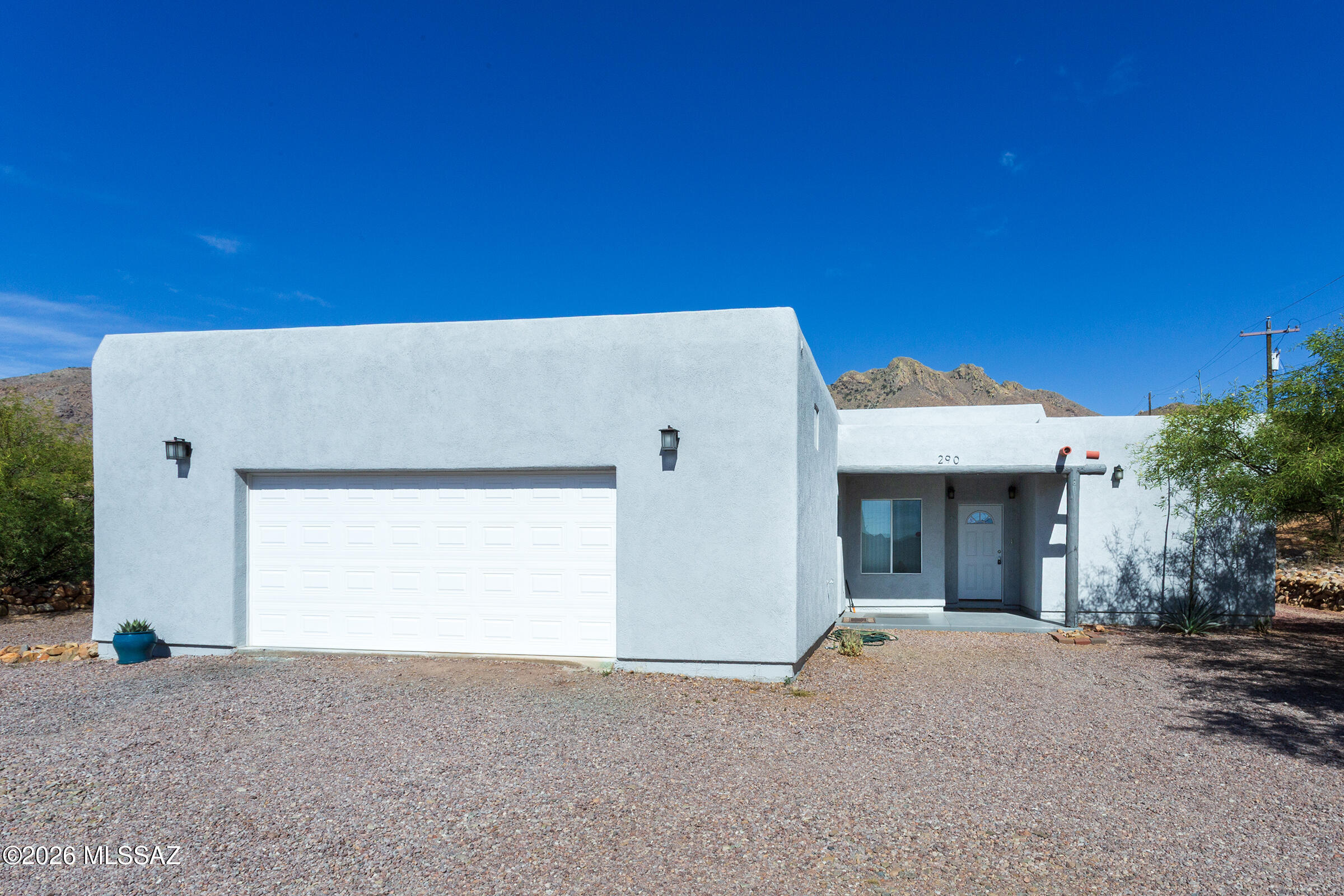 MOVE-IN READY RENTAL! Enjoy privacy, tranquility & breathtaking mountain views in this quality Santa Fe-style home surrounded by beautiful rockwork landscaping. Filled with natural light, this inviting home features updated appliances, washer/dryer, 10ft ceilings in the living/dining & 9ft ceilings throughout the rest of the home. The attractive split floor plan offers privacy & comfort, with sliding glass doors in each room providing easy access to outdoor spaces & stunning views. Primary suite includes a large walk-in closet. A huge garage offers abundant storage, lots of shelving, high ceilings & a workshop area with utility sink. Pets considered with owner approval. Don't miss this opportunity to enjoy peaceful living in a truly special setting!