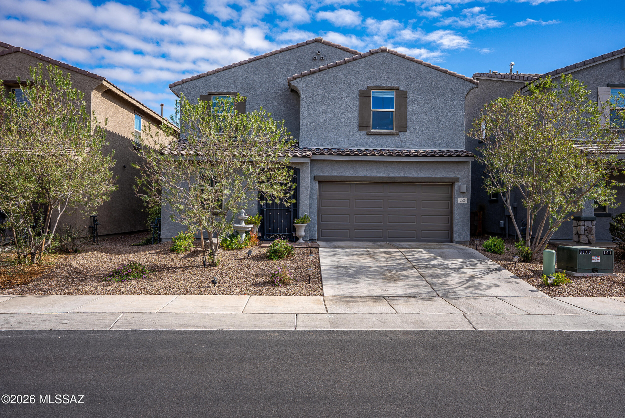 12724 N Watkins Ave in Marana, AZ is a 4-bed, 3-bath home located in the Gladden Farms community. This two-story property features an open-concept layout with upgraded wood-look tile flooring, white fantasy granite countertops, and Whirlpool appliances. The kitchen includes soft-close cabinets, a farmhouse sink, touchless faucet, full backsplash, and a frosted glass pantry door. A custom-built dining bar with cabinetry, wine cooler, and mini fridge adds functional space to the formal dining area. The great room includes an industrial ceiling fan and recessed lighting. Upstairs, the loft is enhanced with barn doors and added lighting. All bedrooms feature ceiling fans, primary suite offers a barn door entrance, rainfall shower, upgraded mirrors, and. . . see more section & upgrades lists and extra extra cabinet storage.

The home is equipped with a full smart-home system, including two thermostats, smart video doorbell, garage door access, smart lock, and alarm system with sensors and motion detection. Energy-efficient features include spray foam attic insulation and a dual-zone HVAC system. The backyard sits on a large premium lot and includes artificial turf, pavers, patio curtains, a ceiling fan, a hot tub, an 8'x10' shed, and an 8'x10' gazebo. Granite rock landscaping with irrigation and an epoxied extended garage with a dedicated outlet add to the functionality of the property. Additional upgrades include a custom front screen door, upgraded bathroom fixtures, soft-close cabinetry throughout, faux wood blinds, and smart entertainment wiring in all rooms.

Located minutes from I-10, this home offers quick access to schools, parks, and shopping centers. It combines energy efficiency, smart technology, and custom upgrades, making it ideal for buyers seeking a move-in-ready home in a growing Marana neighborhood. This property is designed for functionality, connectivity, and low-maintenance outdoor living.