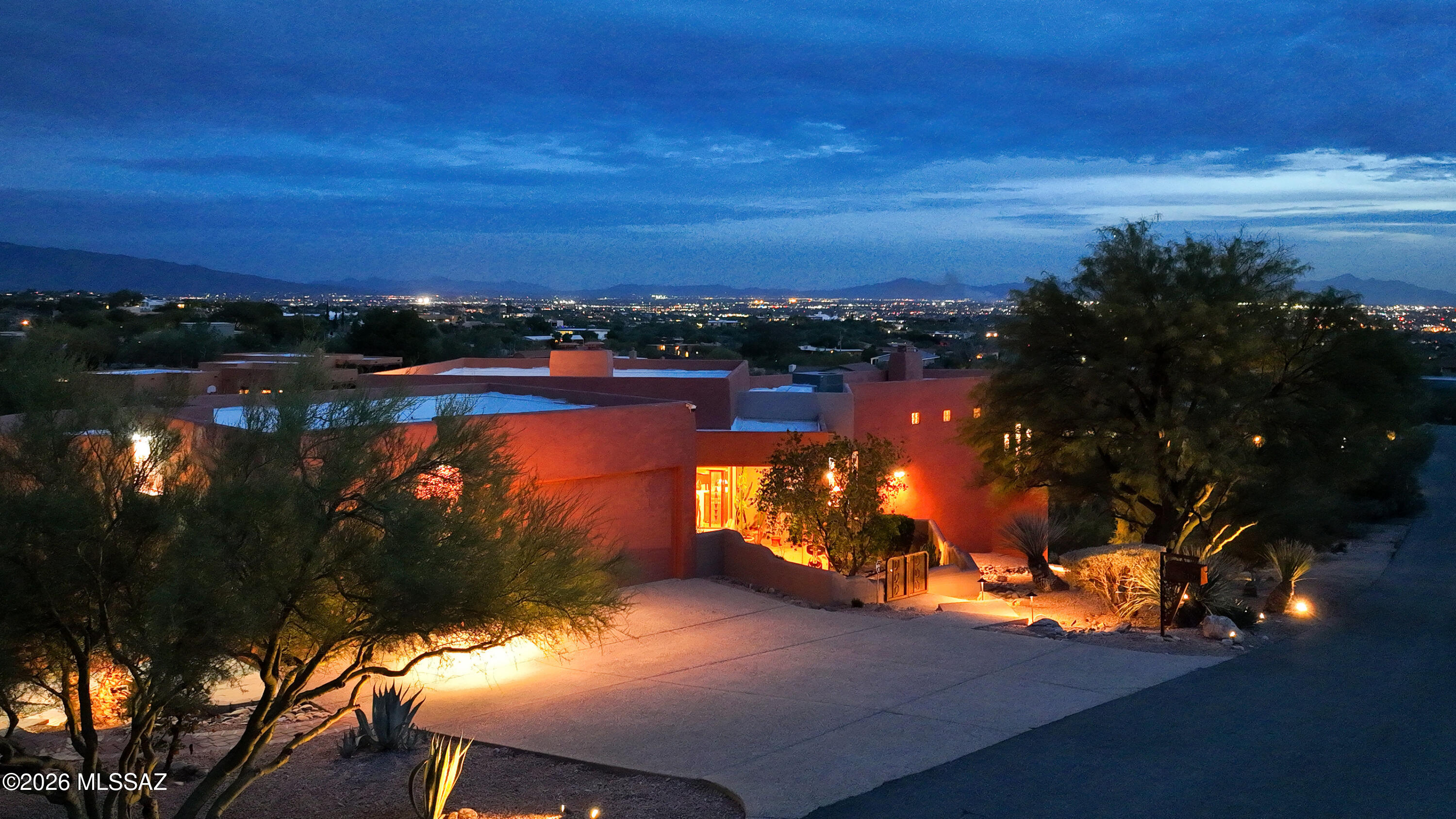 Captivating city lights, mountain views, and the beauty of the surrounding desert landscape provide a stunning backdrop for this meticulously maintained foothills home on 1.24 private acres. Designed to live like a single-story home with flexible guest quarters below, the elevated main level captures the views beautifully while offering the convenience of the primary suite, kitchen, living areas, and three additional bedrooms all on one floor.
Quality finishes throughout include Brazilian cherry flooring, Saltillo tile, travertine, and engineered wood flooring with no carpet. Expansive windows and two private balconies--one off the kitchen and one off the primary suite--invite you to enjoy Tucson's spectacular sunsets, sparkling evening lights, and ever-changing desert scenery. The walk-out lower level provides exceptional flexibility with a separate entrance, private bedroom, living area, bath, wet bar, refrigerator, and abundant storage. Ideal for guests, multigenerational living, a home office, studio, or private retreat, this space offers versatility rarely found in today's market. No HOA.
A three-car garage includes a heated and cooled bay ideal for a workshop, fitness room, hobby space, or additional storage. Combining privacy, quality finishes, an exceptional floor plan, and unforgettable views, this thoughtfully designed home offers a unique foothills lifestyle.  See MLS for a complete list of features, improvements, and upgrades.
