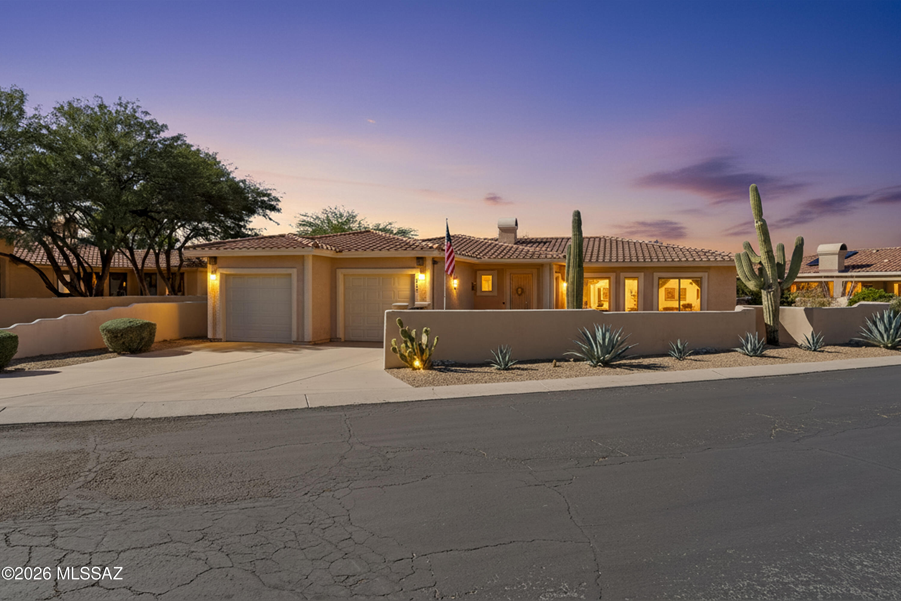 Fabulous former model home with mountain views located in the gated community of Sunstone Estates in the heart of Oro Valley. This tucked away neighborhood with privacy and serenity is just minutes from shopping, amenities, restaurants and a short golf cart ride from Oro Valley Country Club. Home features a wonderful open concept floorplan. Kitchen has cherry wood cabinets, large island, granite countertops, gas cooktop and double ovens. Light and bright living room includes a gas fireplace perfect for enjoying cozy evenings. Owner's suite is oversized with a sitting area, 2 walk-in closets, and large en-suite bath with Jacuzzi tub, shower, and dual vanities. Bedroom 2 has a murphy bed, great for guests. Fully enclosed large lot boasts incredible Pusch Ridge views from the enclosed front yard plus wonderful easy-care landscaping,
citrus trees, flagstone pathways and an in-ground spa with a rock waterfall. Screened in AZ room is perfect for enjoying year-round. Oversized two car garage has room for golf cart plus community pool just around the corner. Spa was replastered and newer spa pump. Luxury living perfect for seasonal home or year-round living.