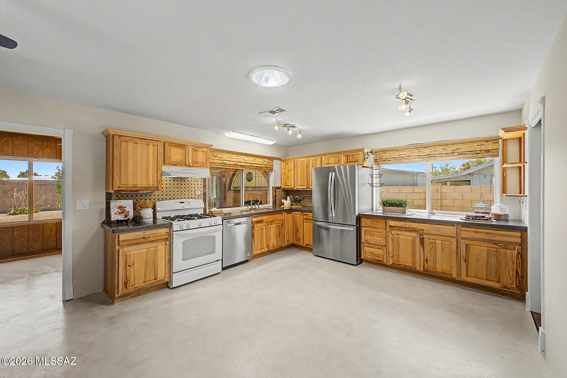 Discover this charming 3-bedroom, 2-bath home in sought-after Wildwood Park! Enjoy worry-free living with major upgrades: HVAC (2018), water heater (2023), new appliances, fresh paint, new carpet, stylish concrete flooring, and a durable metal roof. Located in the highly rated Flowing Wells school district, this move-in ready home is close to parks, playgrounds, restaurants, shopping, hospitals, and the Loop Bike Path. Features include NO HOA, laundry room, pantry, 2-car garage with storage, vinyl siding, a 2-story shed, and RV parking--perfect for gatherings and holidays! Review the upgrades sheet for more details!