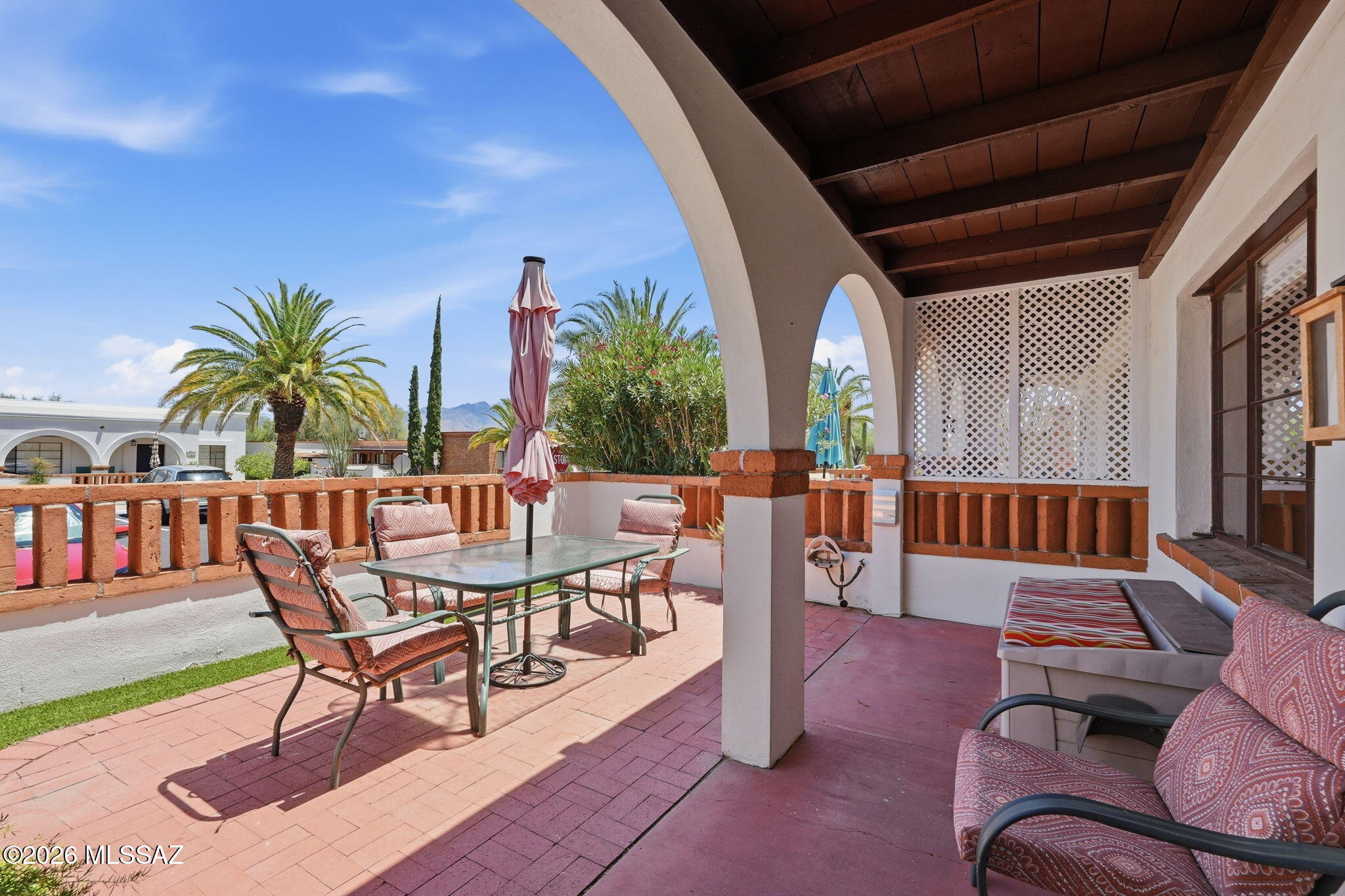 Santa Rita Mountain Views from White Arched Covered & Uncovered East Facing Gated Front Patio of this 648 sq ft 1-bedroom Villa w/enclosed bonus space.  Remodeled Kitchen w/Silestone Countertops, Breakfast bar, Newer Dishwasher, Full Sized Stainless Gas Range/Oven & Newer Full-sized Side by Side Refrigerator w/water & Ice Maker. GE All in One Washer/Dryer. Skylight to bring in natural light or close to watch TV that stays. 2 Closets in the bedroom. Remodeled Bathroom w/tile Walk-in Shower & New Glass Door, a Full-Length Vanity & Linen Cabinet provides ample storage. Ceiling fans + extra lighting. Front & Back Security doors to allow air flow. Tile floors throughout! Astro Turf. HOA/COA covers HVAC, Roof, Water Heater & inc water, sewer & trash. Close to pool, park/s, shopping & restaurants