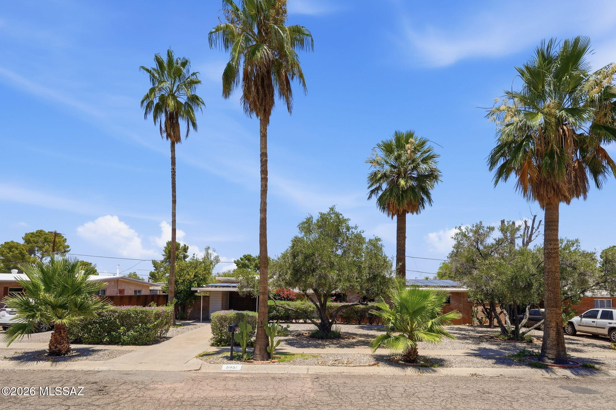 Rare opportunity to own a truly well-preserved Mid-Century Modern home in the heart of Tucson. This 3/2 home showcases the architectural details you've been searching for, including soaring vaulted tongue-and-groove ceilings, mortar-washed brick with distinctive corbel detailing, and a stunning two-way fireplace complete with built-in planters and original vintage 1950s tilework. Thoughtfully maintained over the years, the home pairs its timeless character with major modern upgrades, including a newer HVAC system, newer roof, and owned solar for improved efficiency and peace of mind. A beautifully landscaped entry creates an inviting first impression, while the low-maintenance backyard offers a lush retreat filled with mature plantings and outdoor living potential. Come see soon!