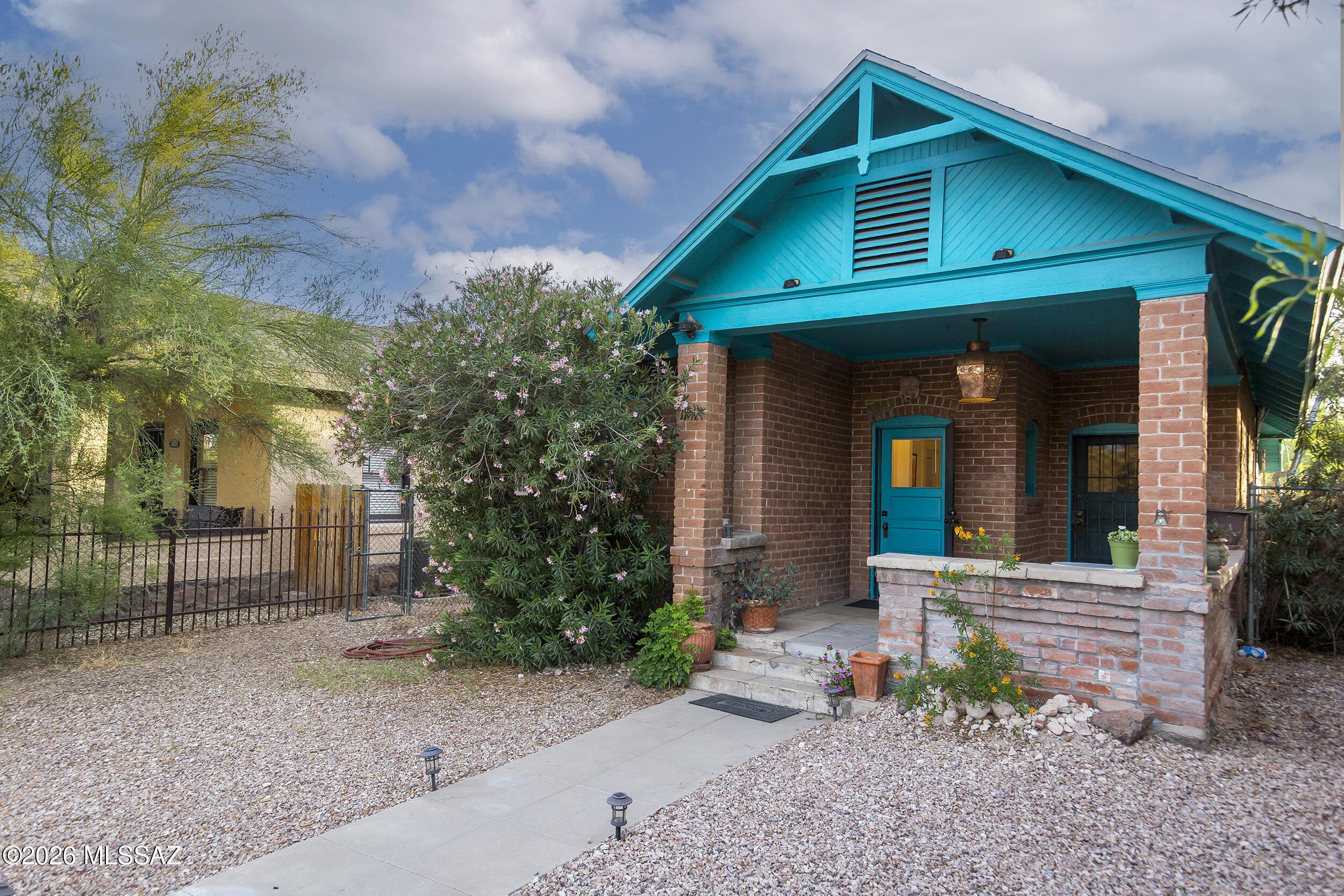 c.1907 bungalow located in the historic West University Neighborhood. Built in the transitional Craftsman style, this 2-bedroom, 1.25-bath home features exposed brick construction along with a foundation and front retaining wall built from quarried volcanic from the base of Sentinel Peak. Two front doors off the front porch originally allowed the owner to either operate a professional practice or rent a room to travelers arriving by rail -- (the early 1900s version of Airbnb ) -- reflecting the property's deep Tucson roots. The more liberal commercial zoning and rear access from Echols Avenue allow for greater flexibility and potential future uses. Ideally located near Downtown Tucson, historic 4th Avenue, the University of Arizona, and a wide variety of restaurants and entertainment venue
