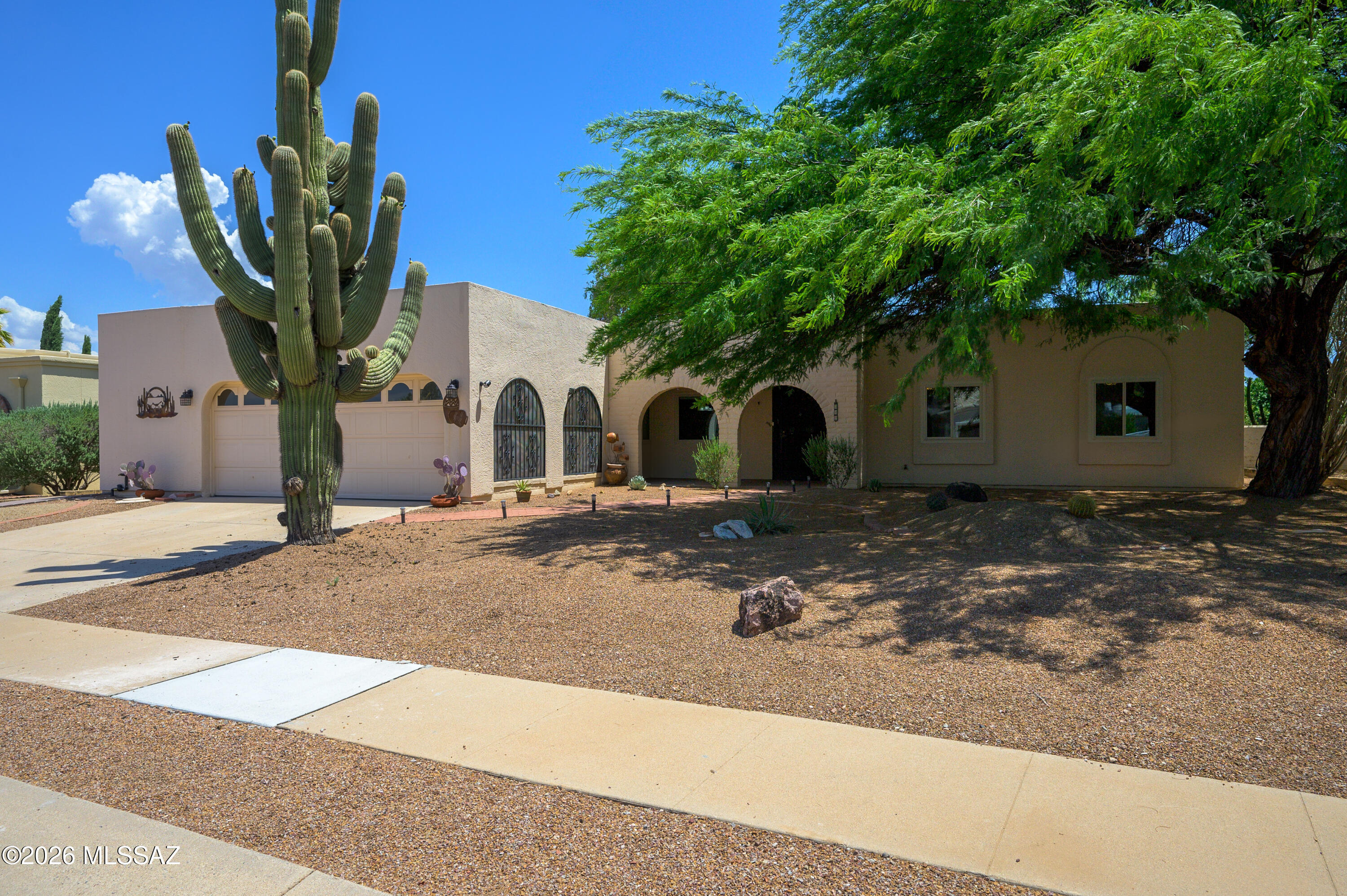 For those not wanting a membership to GV Recreation or uncertain about its value, take a look at this remodeled three-bedroom home. Finding a home without mandatory Green Valley Recreation is difficult, especially one as nice as this. Step into an energy efficient, freshly painted interior sporting newer vinyl thermal windows and sliding glass doors, a 2023 HVAC unit and a new mini-split in the office and workshop adding 264sf of heated and cooled space. Engineered wood floors throughout offer durability, stability and easy maintenance. The attractive wood grain appearance compliments the Stainless-Steel appliances and nickel finish on crisp white kitchen cabinets. The recently installed Kohler Lux Stone showers in both bathrooms create a spa-like experience with enhanced comfort, safety and long-lasting performance. New vanities, vessel sinks and lighting complete the total transformation. Hidden in a quiet cul-de-sac, privacy is an alluring feature of this property. A beautiful mesquite tree shades the front porch while an elevated wall, landscaping and a bit of common area provide an aesthetically pleasing buffer. Relax and move about between the covered, open air or screened patio. This home's spacious floorplan fits all lifestyles with flex rooms and/or seclusion. The choice is also yours to continue without GV Rec or become a member.
