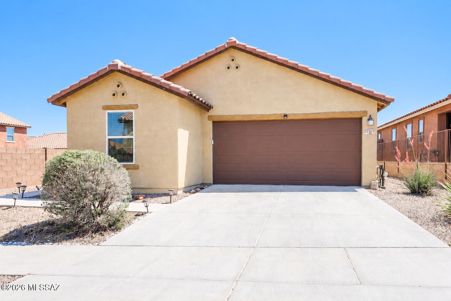 Beautiful single-story 3 bedroom, 2 bath home with a den in the desirable Santa Rita Ranch community. This inviting home features an open floor plan with a spacious great room, dining area, split-bedroom layout, and versatile den ideal for a home office, hobby room, or additional living space. The kitchen offers a large island, gas range, and abundant cabinet and counter space. Washer and dryer convey, along with additional shelving in the laundry room. Solar system helps provide energy efficiency. Enjoy a thoughtfully designed backyard with extended pavers, planter beds, a charming fire pit gathering area, mounted outdoor TV, and low-maintenance turf, all perfectly positioned to take in stunning desert and mountain views. No rear neighbors for added privacy and open views.