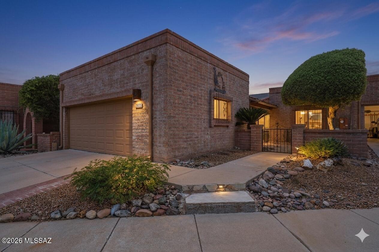 This well-designed home offers approximately 1,625 square feet of living space with two bedrooms and two bathrooms. The primary bedroom features a large walk-in closet, and the home has a laundry closet located in the hall for convenience. Tile flooring is present throughout the living areas, while the bedrooms are carpeted. 
The great room includes a gas fireplace, providing a cozy ambiance. An expansive Arizona room adjoins the great room, offering ample space for relaxation or entertaining. The kitchen is equipped with newer stainless steel appliances, and the interior has been freshly painted.
The home boasts a large two-car garage with additional storage space and a utility sink. The front courtyard provides a pleasant view, and the enclosed entry adds a touch of privacy. MORE...... The covered back patio is accessible from the primary bedroom and the Arizona room, offering a seamless transition to the outdoors. The backyard is adjacent to an arroyo, creating a serene atmosphere.