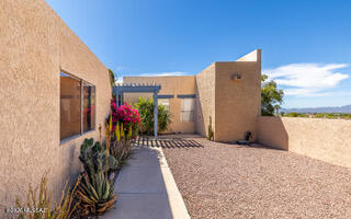Tucked away in the Catalina Foothills ,this end unit
has spectacular  mountain views, colorful sunsets and sparkling city lights. Gated northern courtyard is spacious and has not only mountain views but also city lights & sunset. Extra room can be den, office or anything. you want it to be! Beehive fireplace, lovely mexican tile floors. Neighborhood has a private community pool, lots of walking trails & outdoor areas.Shopping and many amenities are within walking distance.