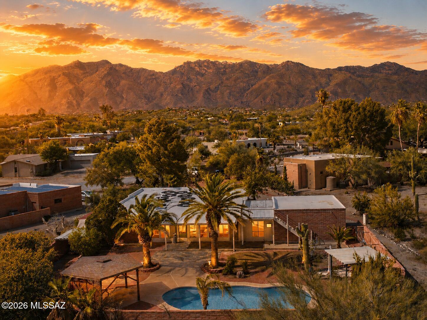 Enjoy breathtaking Catalina Mountain views from the front living room and primary suite, or take in panoramic city and mountain vistas from the private sky deck while sipping your morning coffee or unwinding at sunset. The inviting floor plan blends warmth and character, featuring a cozy wood-burning fireplace, charming peek-a-boo exposed adobe brick accents, a spacious Arizona room, and a versatile bonus space that can serve as an art studio, home office, den, fitness room, or whatever your heart desires.

The updated kitchen is both stylish and functional, showcasing quartz countertops and new stainless steel appliances, making it a wonderful space for everyday living and entertaining alike. Designed for year-round Arizona living, the home offers multiple outdoor entertaining spaces, including a screened and open-air patios perfect for gathering with friends or enjoying a quiet evening under the stars. The sparkling solar-heated pool serves as the centerpiece of the backyard oasis, surrounded by mature landscaping, fruit trees, and a unique collection of desert vegetation that creates both beauty and privacy.

Whether hosting guests or seeking a peaceful retreat, this well-maintained home captures the essence of Tucson desert living. Located in one of the Foothills' most sought-after communities, it combines character, views, flexible living spaces, and major recent upgrades in an unbeatable location. Don't miss this rare opportunity to own a special property in Sunrise Presidio Village.
