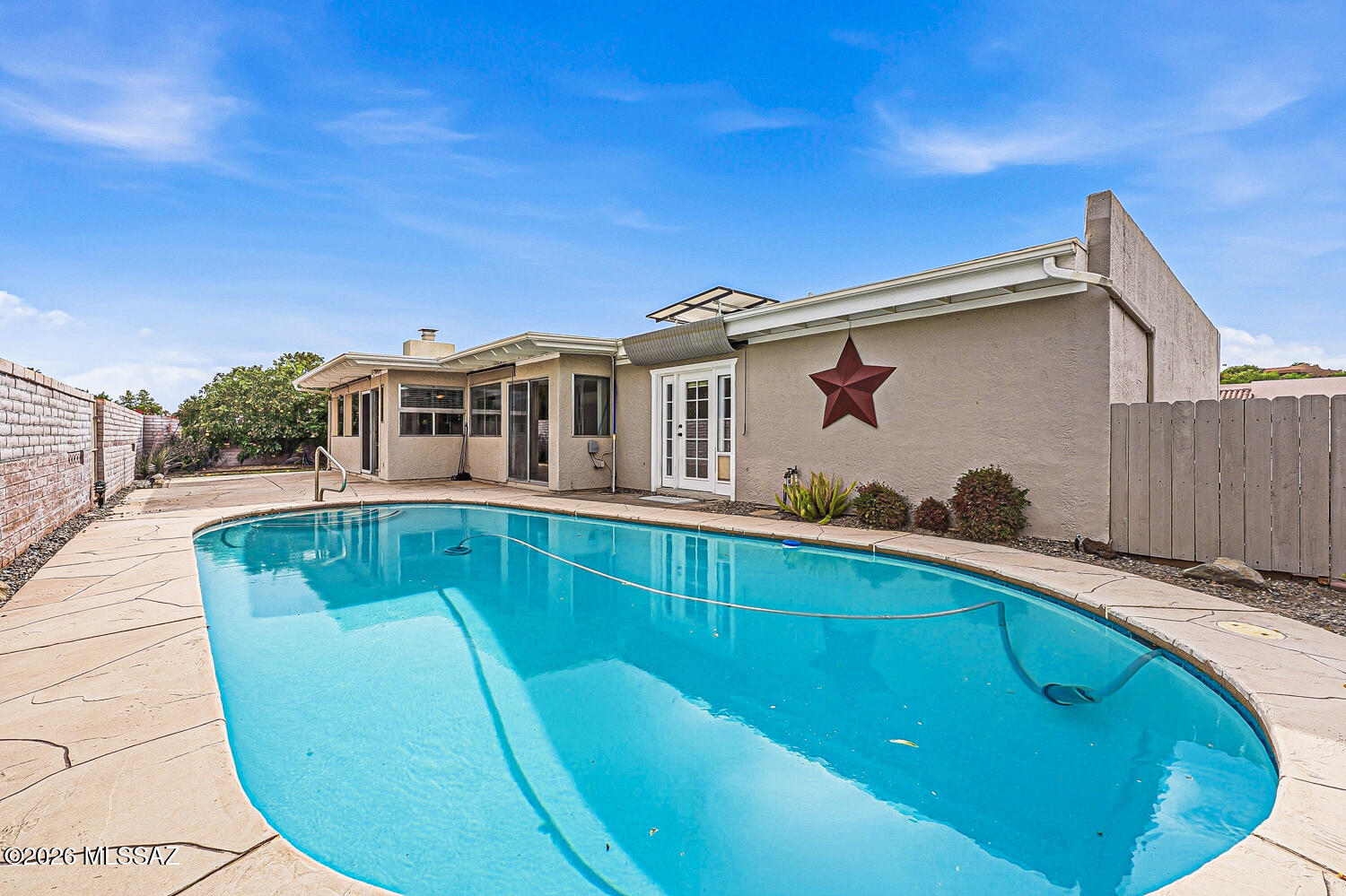 POOL + BONUS ROOM + LOW HOA--THIS ONE HAS IT ALL! 
This beautiful and spacious 3-bedroom, 2-bath home offers approximately 2,065 sq ft of flexible living space, highlighted by an inviting family room featuring a cozy wood-burning fireplace, an ideal setting for gatherings. The kitchen is designed for functionality and style, showcasing Corian countertops, updated modern appliances, a desirable gas stove with double oven, abundant cabinetry, generous counter space, and a breakfast bar that flows seamlessly into the dining area. Major updates provide peace of mind, including a newer roof (just 3 years old), exterior paint completed 3 years ago, an upgraded irrigation system (2023), and new pool equipment (2023). The home features tile and laminate wood flooring throughout, a recirculating hot water system, and mini-split units in the family room and bonus room (2021), all complemented by Andersen windows at the front of the home. The owner's suite offers a walk-in closet and direct access to the backyard pool area through a patio door, perfect for enjoying Arizona living. Two additional bedrooms and a full guest bath offer comfortable space for family and visitors. A flexible bonus room adds even more possibilities, ideal as a home office, craft room, or hobby space. Step outside to your private backyard retreat, complete with a sparkling pool, perfect for enjoying the Arizona sunshine year-round. Enjoy added efficiency and savings with a leased solar system. All this with an incredibly low HOA of just $35/year and access to Green Valley Recreation amenities, including pools, fitness centers, pickleball, art classes, and a wide variety of social activities within this desirable 55+ community. Owners is a licensed Real Estate Agent in Texas