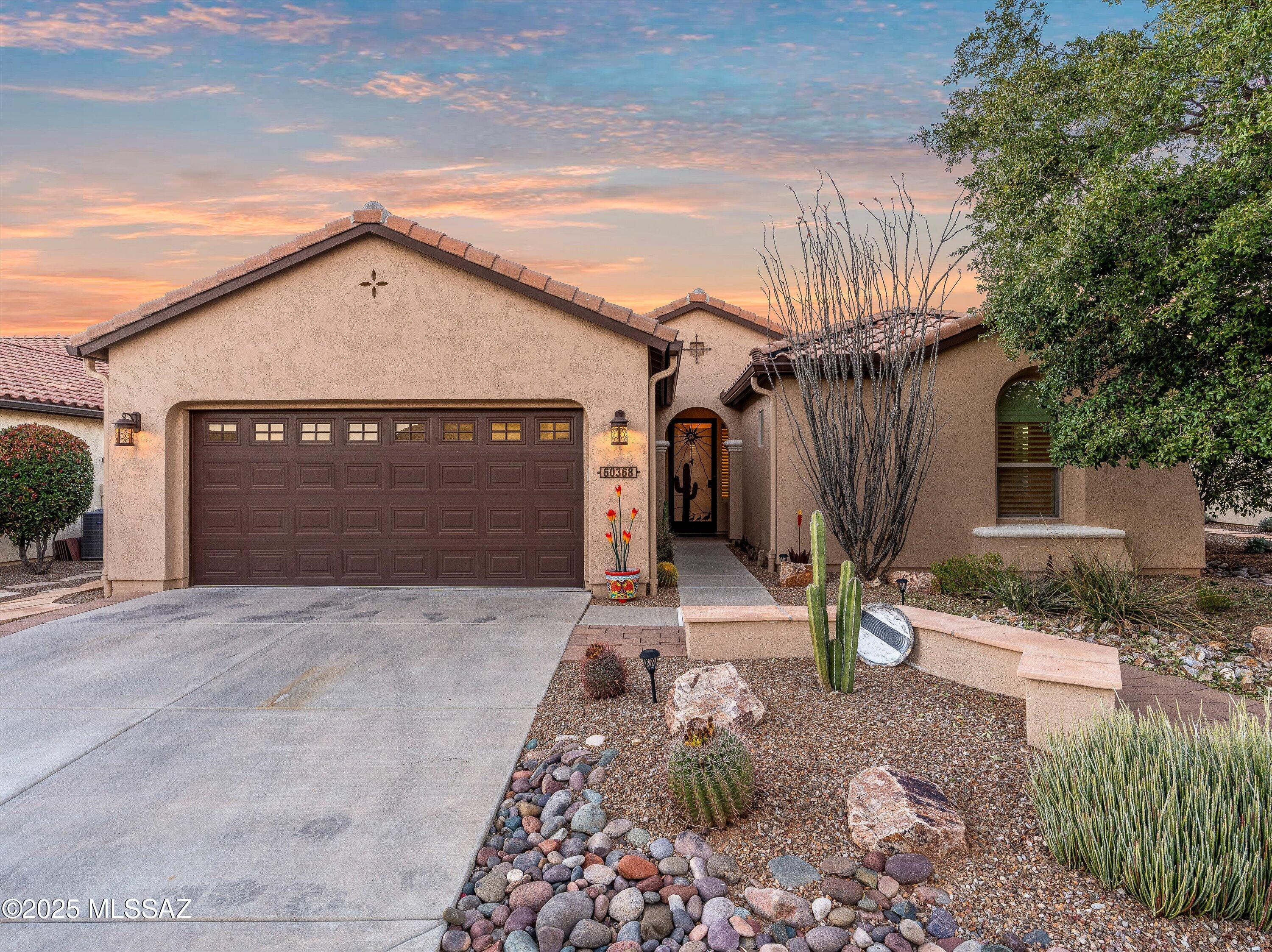 Enjoy sweeping panoramic vistas of the adjacent common area, golf course, and the dramatic mountain backdrop from the backyard, offering a daily canvas of breathtaking sunsets. This very affordable and beautifully appointed Bella 1 home showcases upgraded appliances and timeless plantation shutters, creating a refined interior ambiance. The decorative floating shelves in the Great Room and in the Den/Office add a personal touch, providing both style and function. The primary bedroom is a serene retreat with a charming bay window that frames the views. Outdoor living is elevated with an extended patio featuring a cozy kiva fireplace, the perfect spot to gather as the sun sets.  Add to that the world-class amenities of this award winning Robson 55+ community. A wonderful place to retire!