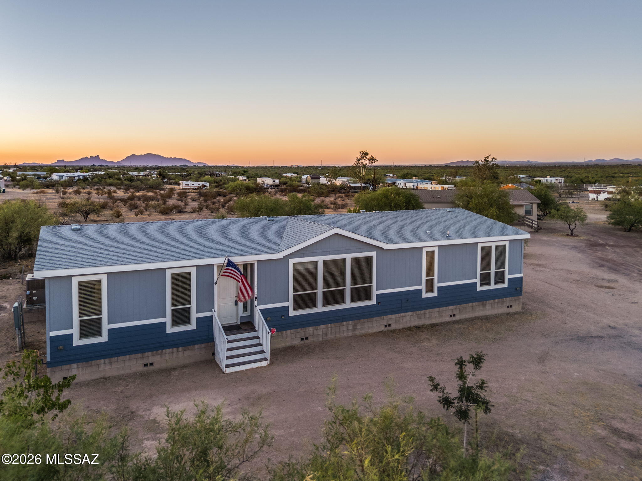 Rare opportunity in Marana! Situated on a full 1-acre lot with NO HOA, this unique property features two manufactured homes--one built in 2021 and the other in 2005. The 2021 home showcases a gourmet kitchen with modern finishes, a spacious open floor plan, and a luxurious spa-inspired walk-in shower in the primary suite. The property offers two separate fenced yards, providing privacy and flexibility for multi-generational living, tenants, or guests. Step outside to enjoy the sparkling pool, perfect for relaxing or entertaining. The 2005 home is tenant-occupied with a lease in place through February 2027, generating $1,800 per month in rental income. Shared water meter, separate electric and gas meters. Whether you're looking for an income-producing property, space for extended family, or versatile investment, this one-of-a-kind property offers endless possibilities.