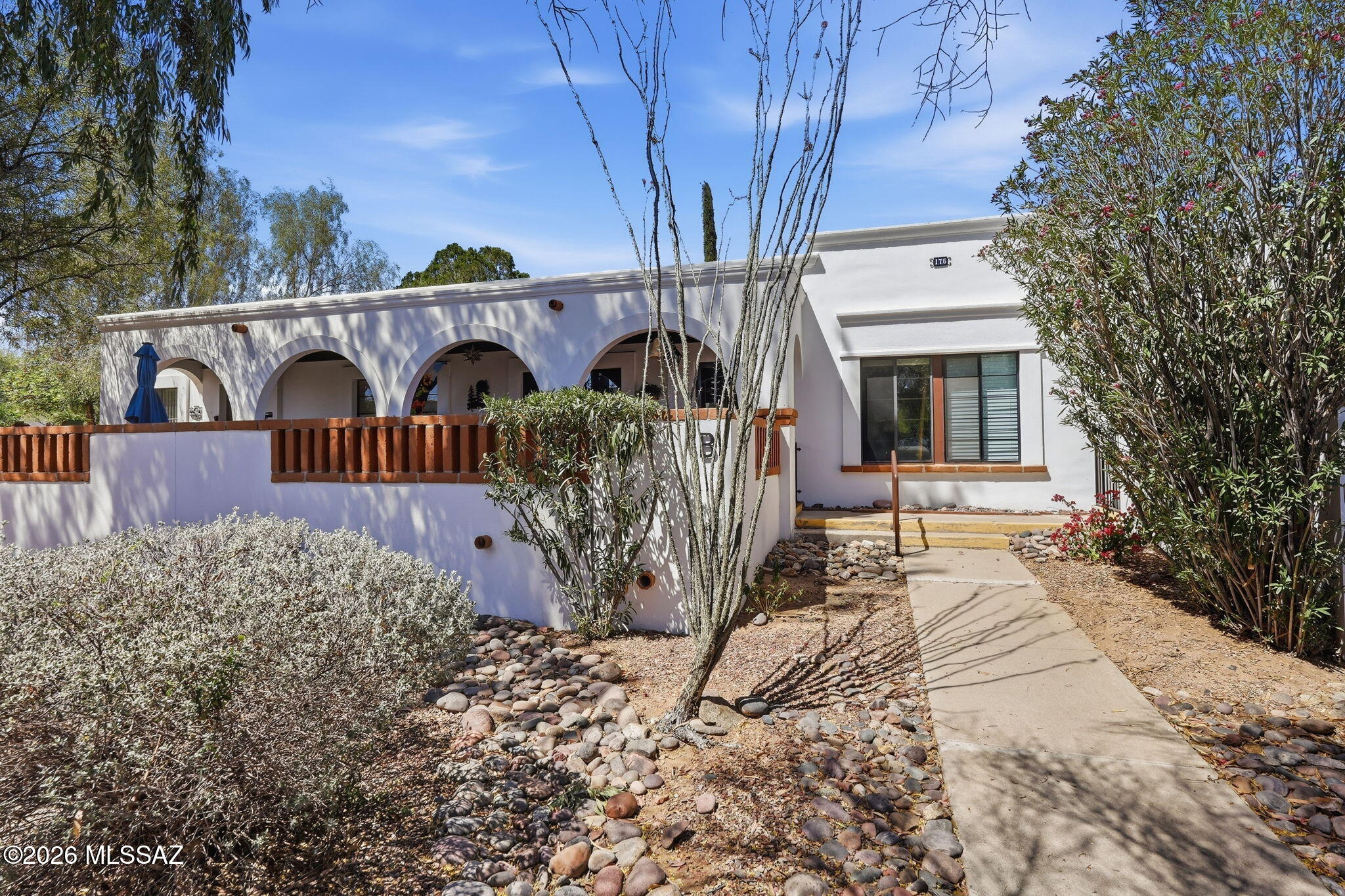 Meticulously maintained, 1BR villa in Villas West with a glass entry door and beautiful wood plank ceramic tile throughout. You'll feel like you're in AZ with a flair of Southwestern style. Mostly furnished, the remodeled kitchen features newer cabinets, breakfast bar, reverse osmosis, stainless Whirlpool appliances, gas range, and ample counter space. Dual-pane windows with top-down/bottom-up blinds add comfort and efficiency. Relax on the private patio overlooking a green park with mature trees, just steps to the pool and laundry. HOA covers roof, HVAC, water heater, trash, pest control, exterior maintenance, and more. Ideal winter retreat or easy year-round living! Designated parking space just for you and ''visitor'' spots available. This is one you will want to see! Move right in