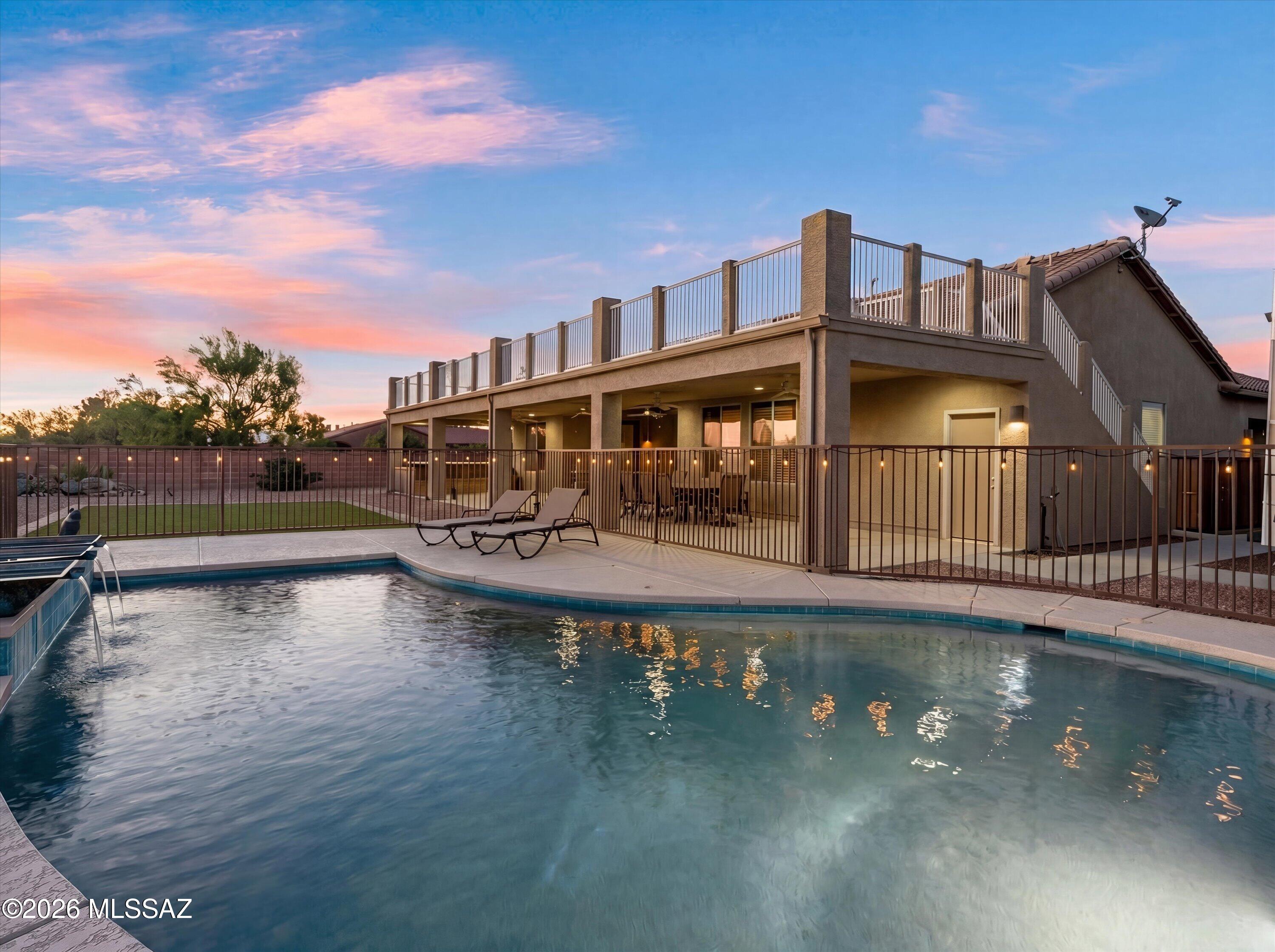 Looking for a UNICORN in your search for the perfect home? MISSION ACCOMPLISHED! Better than new and aged to perfection, this 3 bed/2.5 bath (plus den) single story gem boasts pride of ownership at every turn. Sellers have spared no expense in creating an oasis that you will never want to leave. This rambling ranch on a half-acre lot gives you the space you desire, and an opportunity to put your own touches on the home; while all the 'big ticket' items have been taken care of for you! Enter the inviting courtyard and foyer into a spacious split bedroom floorplan that includes a den and dining area that can easily become additional living spaces as desired. The large eat in kitchen is a cook's delight and provides ample storage space and is open to the living room. The primary suite is an indoor oasis that boasts an ensuite with 2 LARGE walk in closets, dual sinks, a soaking tub, and separate shower. Some of the most impressive highlights are found outside poolside! Here you will enjoy your private custom pool with beautiful water feature; and an outdoor custom kitchen that makes entertaining easy. Don't miss the custom iron staircase that leads to an enviable deck/viewing area for an encore of additional oohhs and aahhs! This home has owned solar for huge savings on utility bills; a 2-car freestanding garage plus 3-car attached garage with workshop area; newer HVAC, roof, and water heater. Close to restaurants, shopping, I-10 and more! Be sure to watch the VIDEO!