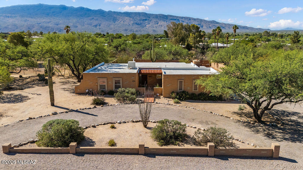 Welcome home to this beautifully maintained 3-bedroom, 2-bath residence, thoughtfully designed for comfortable everyday living and effortless relaxation. Situated on a generous 0.79-acre lot, this inviting property offers plenty of space to enjoy Arizona's outdoor lifestyle. Spend warm summer days cooling off in the sparkling pool, then unwind in the evenings as the desirable north/south orientation creates a comfortable backyard setting perfect for entertaining or simply enjoying the peaceful desert surroundings. The low-maintenance front and backyard feature attractive desert landscaping that complements the natural beauty of the Sonoran Desert while providing year-round curb appeal. Conveniently located near Agua Caliente Park, Sabino Canyon, and Saguaro National Park East, outdoor adventures are always within reach. You'll also enjoy easy access to golf, recreation, shopping, and dining, making this home the perfect blend of tranquility, convenience, and Southwest charm.