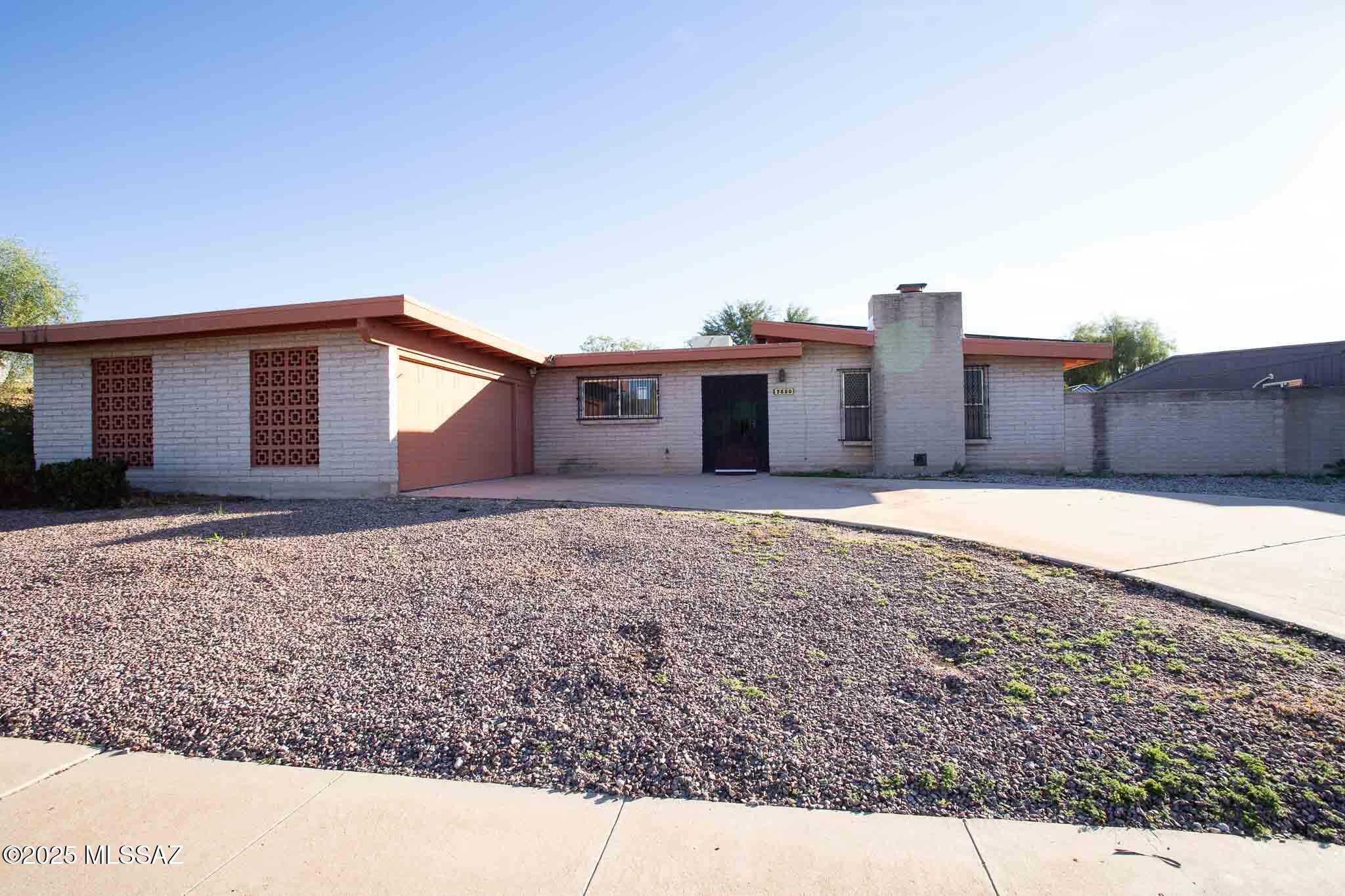 Spacious 4-bedroom, 2-bathroom slump block home with a 2-car garage and pool located in an East side subdivision with no HOA. Owned and paid off Solar system, offering reduced monthly utility costs with no solar payment to assume. Interior features include tile in all the right places, a red brick fireplace and exposed wood beams in ceiling in the formal living room, plus a second fireplace in the great room. The kitchen offers stainless steel appliances and plenty of cabinet space. The backyard includes pool and enclosed screen-covered patio for those hot summer days. Home is equipped with a 2023 Trane air conditioner and heater. Call Agent for more details.