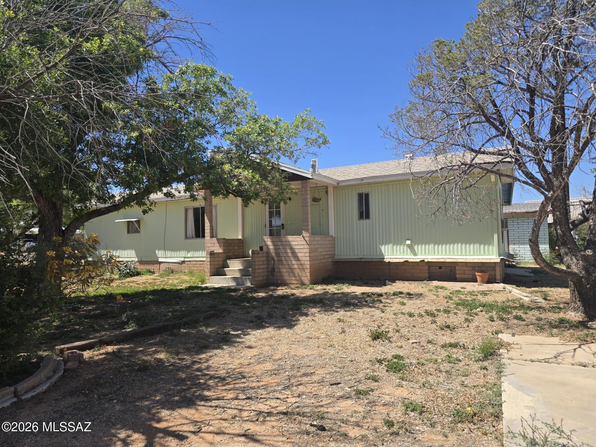 Country Cousin Cutie Welcomes you home!
One bedroom, one bath PLUS Basement.  Carport, plus separate detached garage. Two sheds, one with washer and dryer, plus chicken coup and small animal barn.   Drive in gates at chain link fenced corner lot, with entrance at both Ligier Street and Tortoise Trail.