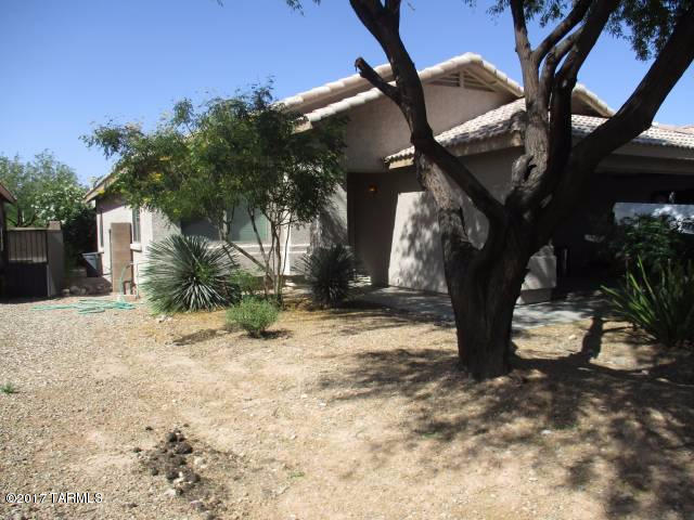 This 1297 sq. ft. 3 bedroom, 2 bath single story upgraded open concept, Mesquite Ranch home has many upgrades for you to enjoy.  The kitchen offers stainless steel appliances.  Tile and wood laminate flooring.  Updated granite counter tops in bathroom, large master suite, 2 car garage, laundry room, block fence, covered patio, landscaped yard with mature trees. Home is in the Vail School District.  Enjoy the Community pools, park and more.  You will be close to shopping and more.  Easy freeway access.
