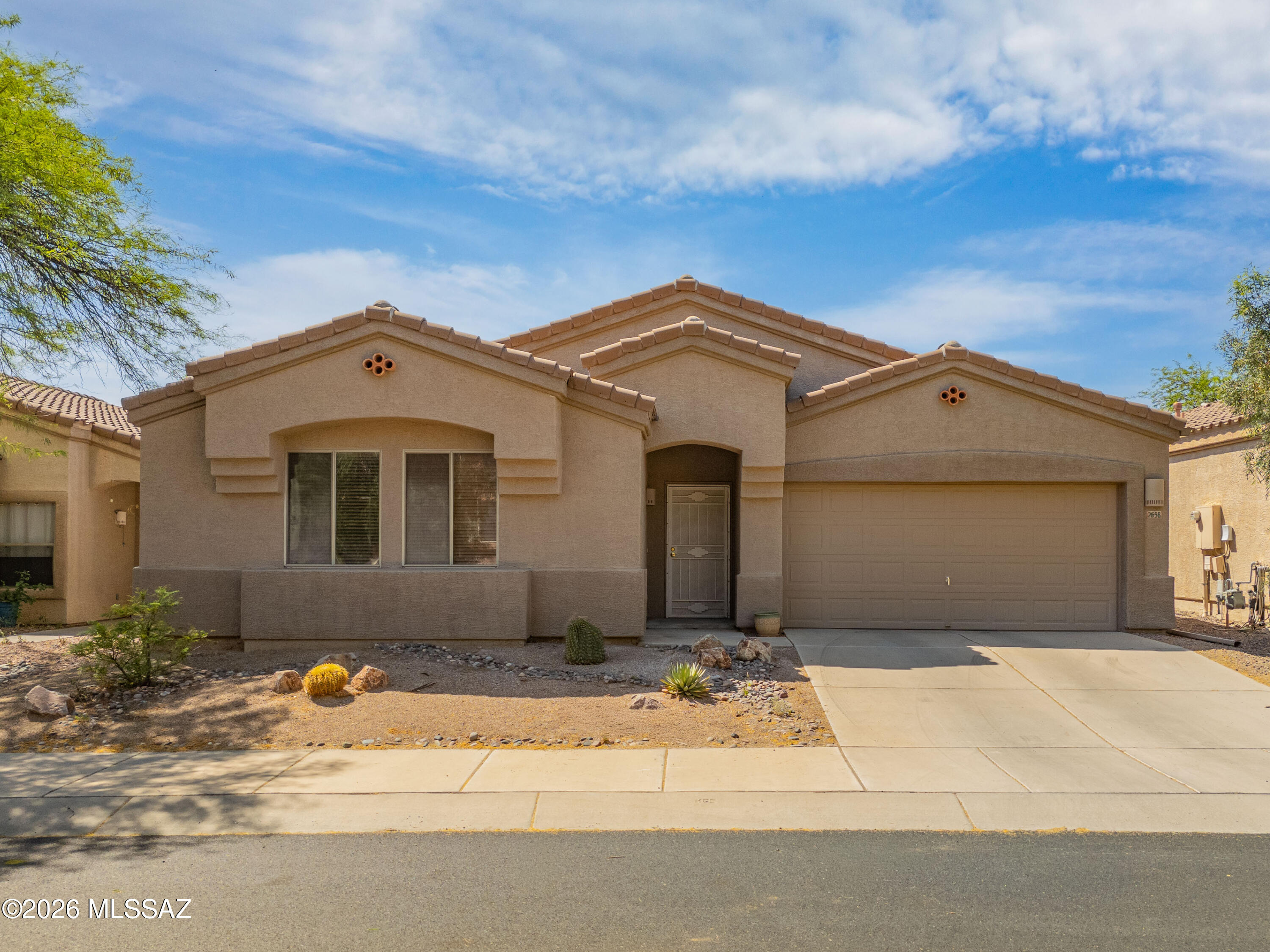 Beautiful well maintained home! 9' ceilings make this home live larger than the sq. ft. Charming kitchen w/spacious eat in area. Have coffee and enjoy looking out your bright sliding glass doors. Covered patio leads to a pristine walled yard. Back inside you will find a kitchen with newer appliances, pantry, ample cabinetry & double sink. Tile & wood laminate floors throughout. Great room with 3 clerestory windows. Laundry room w/upper cabinets. 3 br, 2 ba, spacious owners suite. Owners bath offers a separate soaking tub, shower, 2 sinks and a nice walk in closet. Garage with shelves and workbench.