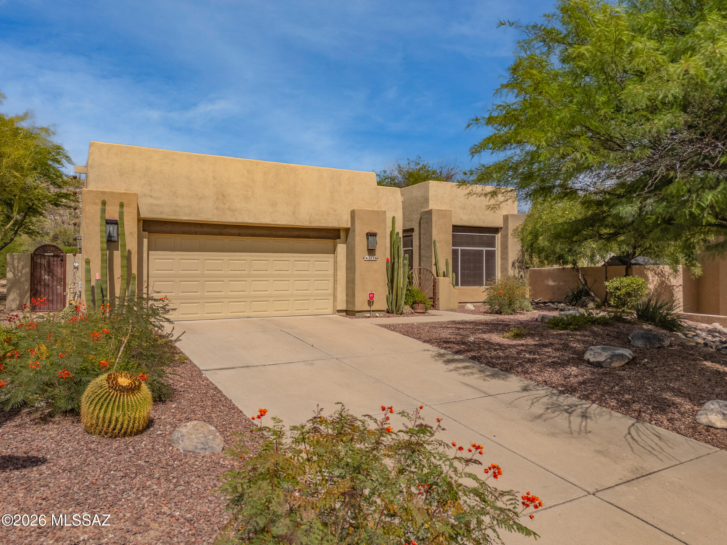 Foothills SW Contemporary styled home. Updated kitchen with ss/ appliances that opens to family room with fireplace, Formal living/dining area, high ceilings, and multiple ceiling fans. Storage cabinets in garage. Easy care front and rear yards with desert plantings and trees, covered patio, sparkling pool with swim jets, enjoy the mountain views in leisure from your backyard oasis. Close to shopping, restaurants, and Sabino Canyon Recreation Area.