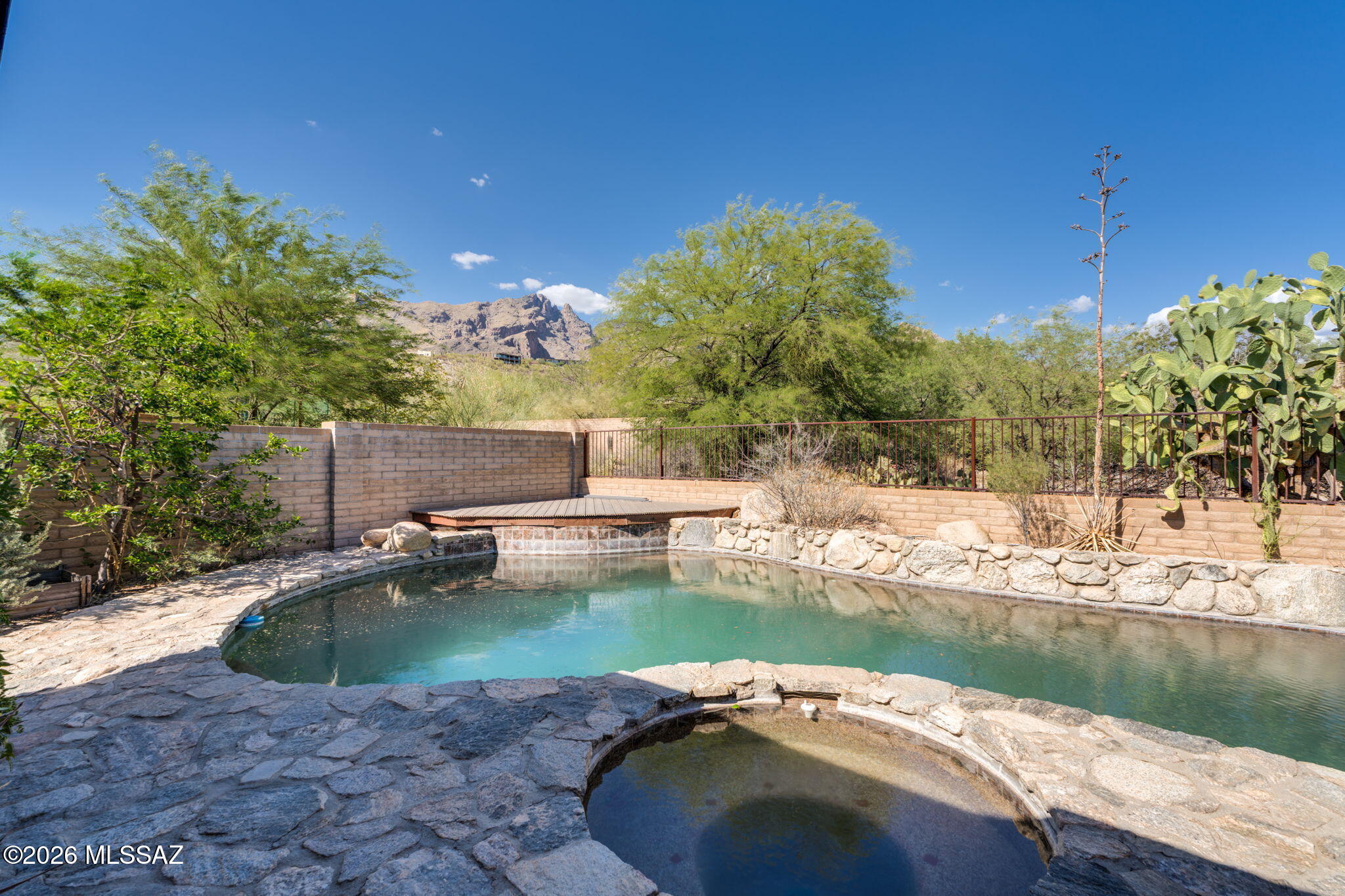Enjoy breathtaking Finger Rock and Catalina Foothills views from this private 3-bedroom + office, 2-bath home nestled among the natural beauty of the Catalina Foothills. The spacious great room floor plan is designed for effortless living and entertaining. Fresh interior paint and stained concrete flooring throughout mean there's no carpet to maintain. Step outside to your private desert oasis featuring a sparkling Pebble Tec pool, relaxing spa, removable pool safety fence, and a brand-new Trex deck perfectly positioned to capture Arizona's unforgettable mountain vistas. The attached 2-car garage offers ample storage, while the desirable location places you just minutes from La Encantada, world-class hiking, and top-rated District 16 schools.