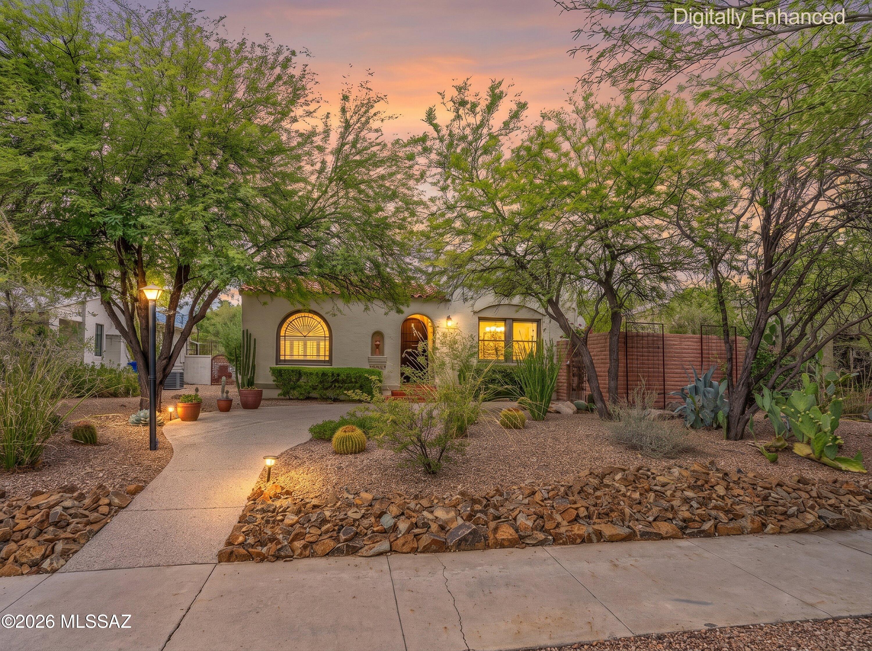 Beautifully maintained 1936 residence in the heart of the highly sought after Sam Hughes neighborhood, where historic charm meets modern comfort. Hardwood floors, coved ceilings, abundant natural light, and classic architectural details create a warm, inviting atmosphere. Updated kitchen opens to comfortable living and dining spaces, while the spacious primary suite offers a peaceful retreat. Detached guest house with private entrance provides exceptional flexibility for visitors, home office, or potential rental income. Enjoy Arizona evenings on the covered patio surrounded by mature landscaping and a private backyard. Just minutes from the University of Arizona, Banner-University Medical Center and Rincon Market. Home offers the perfect blend of historic character, modern convenience.