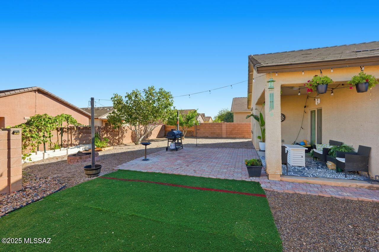 Range Pricing!  Seller will entertain offers between $289,500.00 and $305,000.00. Nestled in the serene beauty of the Sonoran Desert, this inviting home features soft neutral tones and comfortable blend of tile, vinyl, and plush bedroom carpeting.  This home has a great open floor plan.  The kitchen is equipped with an updated dishwasher and refrigerator.  Step outside to a private, peaceful backyard designed with pavers, decorative rock, turf, and fruit trees including lemon, peach, and fig.  Optional string patio lights add an extra touch of charm to this relaxing outdoor space.  Washer and dryer do not convey.