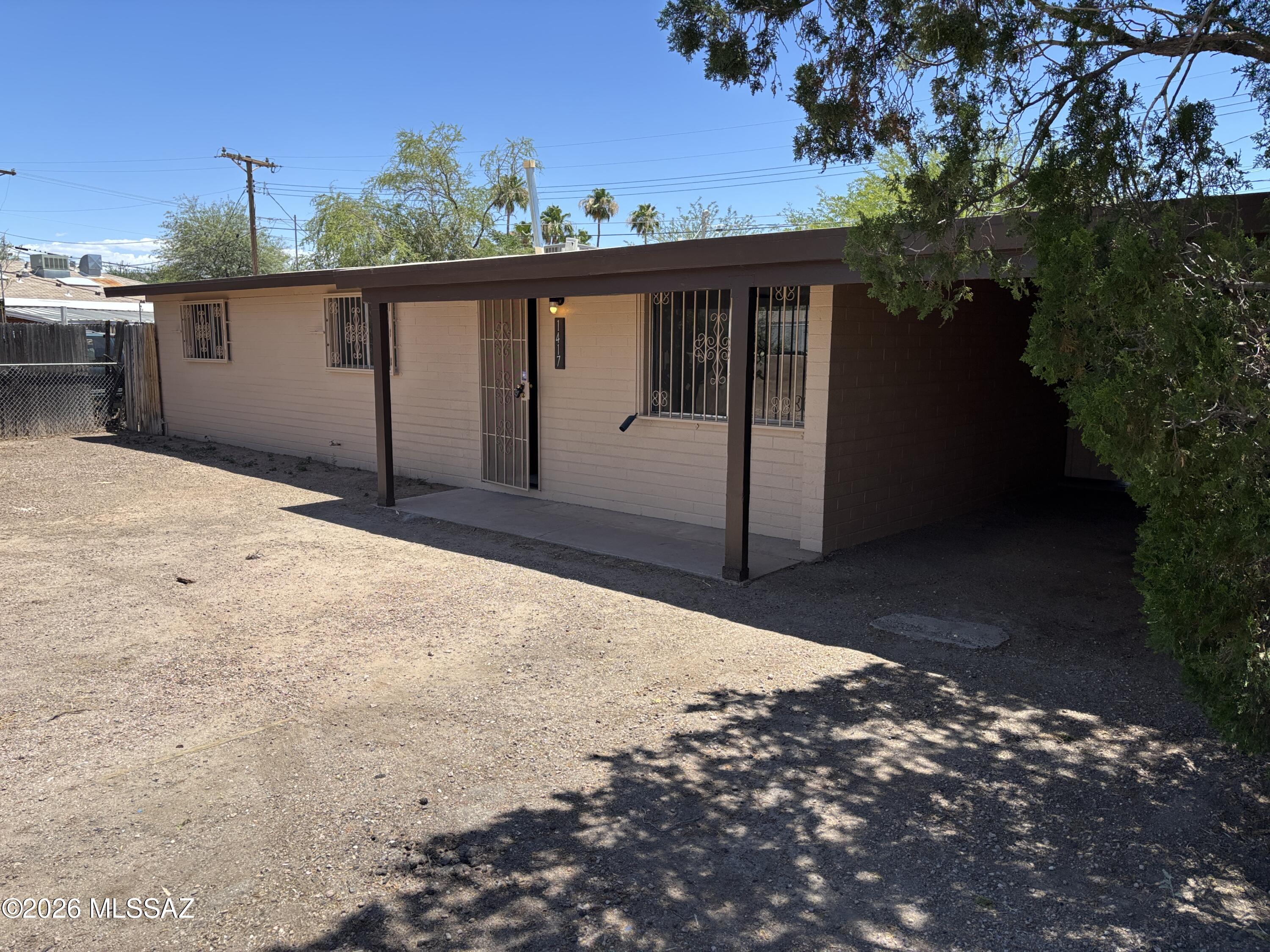 Now available is a 3 bedroom 1.5 bath house. Seller is offering a 3% concession to the buyer with an accepted offer!! This property features a new exterior paint, a single car carport, tile flooring throughout, brand new granite countertops and a new AC installed in 2025 and a new roof in 2026. Roof comes with a 2 year warranty. The huge covered back porch also has an attached, extra large storage room. House also has washer and dryer hookups and a fenced backyard. A new stove and refrigerator will be ordered and installed before close of escrow. This home is across the street from Douglas Elementary School, has easy access to I-10 and is near the Tucson Mall, libraries and restaurants.
