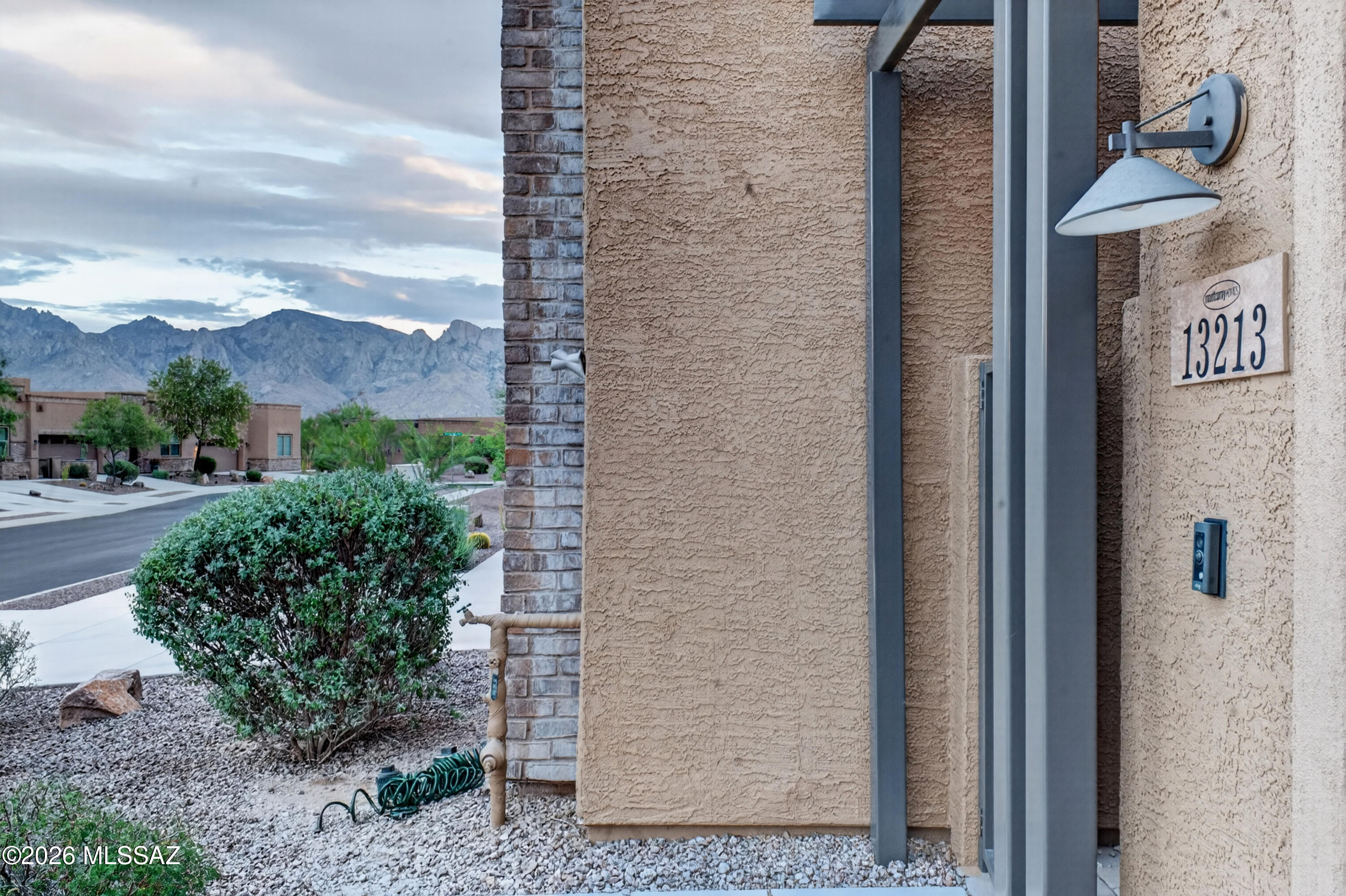Two private spaces, one gated Oro Valley address. Built in 2019 & wrapped in mountain views, this 1,802 sq ft home pairs a single-level main house with a fully separate casita - a genuinely flexible setup for guests, a home office, a studio, or added income potential. The main house centers on a spacious primary suite & a versatile den with 10-foot ceilings, plantation shutters, & ceramic tile throughout. The open kitchen delivers an oversized granite island, gas cooktop, reverse-osmosis system, & ample storage while the primary suite includes ADA adaptations & a ramp for step-free access. Step outside to a welcoming front courtyard & a landscaped, low-maintenance backyard built for easy lock-and-leave living. Behind the gates, residents enjoy a community pool, spa, BBQ area, & green space