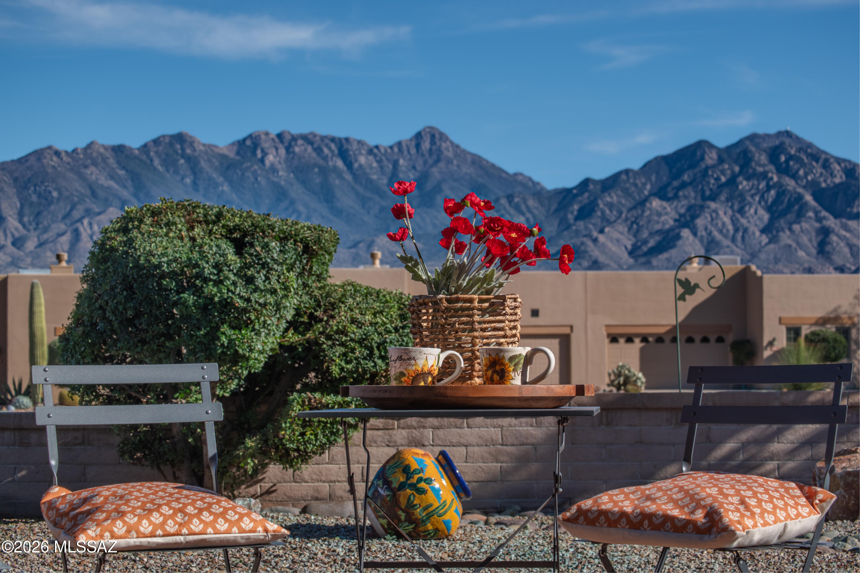 Enjoy breathtaking views of the Santa Rita mountains from the comfort of your great room, where cooking, dining, and entertaining flow seamlessly in this split bedroom plan townhome. Granite countertops and newer appliances make meal prep a pleasure - grab your coffee and catch some morning rays on the back patio. With two en-suites, this home is ideal for visiting friends and family.  The main bedroom suite sports access to laundry, and both bedrooms offer generous storage. A den directly off the great room gives you even more work and play options. Topping it off, your gated community is home to the premier Santa Rita Springs GVR recreation facility (fitness, pool, clay studio, and more), as well as beautifully maintained (by the HOA) walking trails, cactus gardens, and parks.