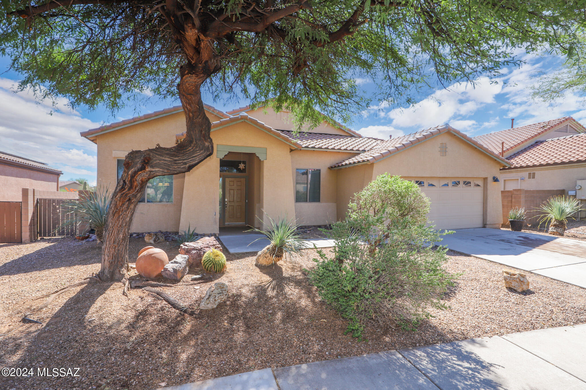 Welcome to your spacious 4 bedroom, 2 bathroom single level home. Many upgrades, NEWer ROOF, including tile flooring and wood laminate throughout with no carpeting, 9' ceilings, two tone neutral paint, upgraded window blinds and ceiling fans in each room. Large living room, separate family room, formal dining area and separate dining nook. Open kitchen features breakfast bar, Corian countertops, separate pantry, large island, additional upgraded cabinets, gas range, stove top microwave, dishwasher and refrigerator. This split-level floor plan has a large primary suite includes a walk-in closet, double sink vanity, large garden tub and separate shower. Large backyard with no neighbors to the rear, easy to maintain desert landscaping,
