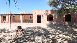 This unique property has distinct Old West Charm! Three houses with rental potential and lots of storage. 2 bedroom 2 bath home (1578 sq. ft.) that's handicap accessible, guest house with 1 bedroom and 1 bath (600 sq. ft.), third home is nicely updated with 1 bedroom and 1 bath (1,000 sq. ft.) with separate laundry room and storage. Spacious wood shop could be great for your hobby area, separate cantina that can be used for office or Air BNB. Homes are on Pomerene water plus private irrigation well, drip system installed for trees and plants at the 1094 property. The entire 5.56 acres are fenced and cross fenced perfect for horses and livestock.