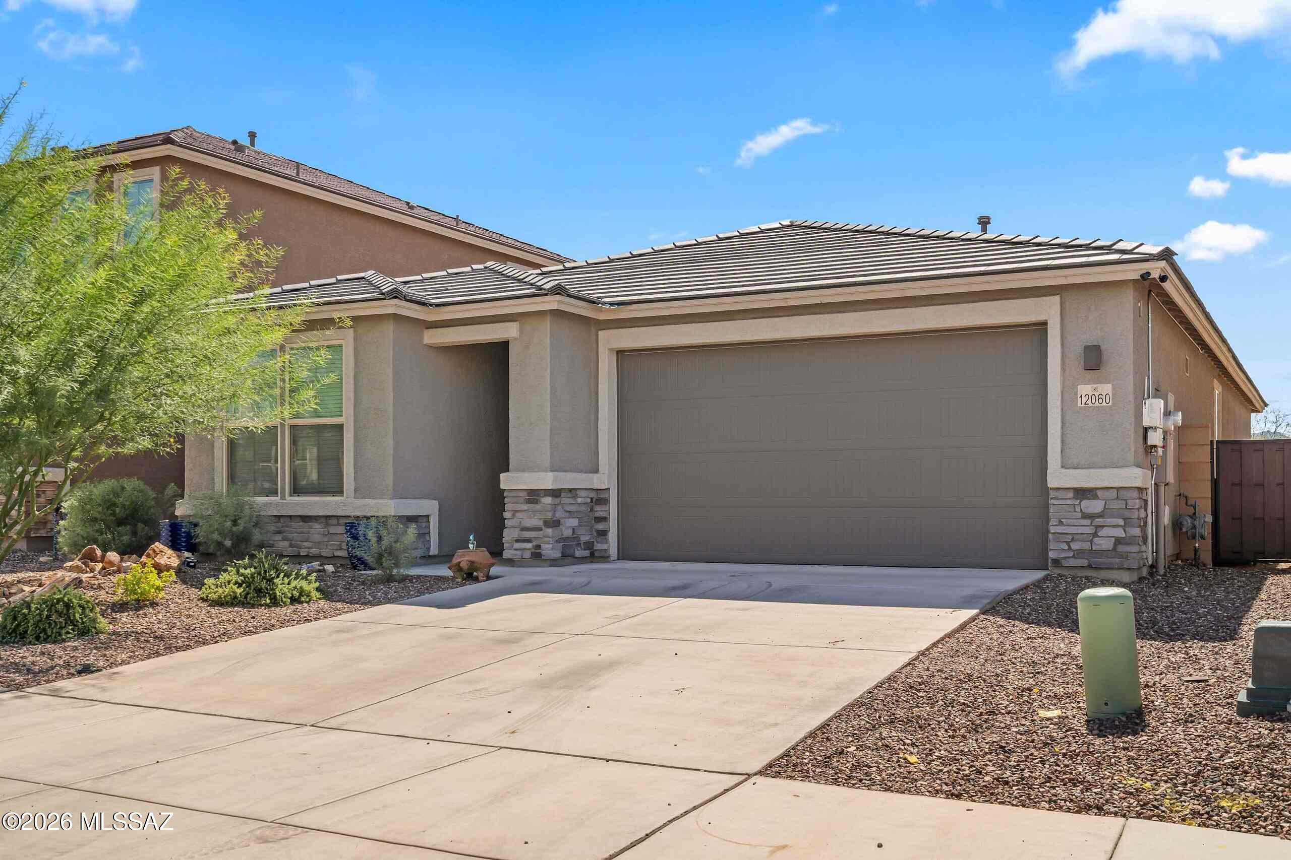 Welcome to this charming Vail home nestled in a serene desert landscape with NO rear neighbors! With a convenient split-floor plan, this four bedroom three FULL bathroom home has all the space you could need! With stylish, trending upgrades like pendant lighting, granite countertops throughout the house, and remote-controlled ceiling fans in every room, you will fall right in love with this place! The Open Concept Kitchen is the perfect place to host, entertain, and create lasting memories. Additionally--to keep energy costs low year-round--this home is fitted with a terrific solar energy system which significantly offsets your electric bill! For security and convenience, the front door is equipped with a state-of-the-art Schlage WiFi Connected Deadbolt. The search is over, come and see!