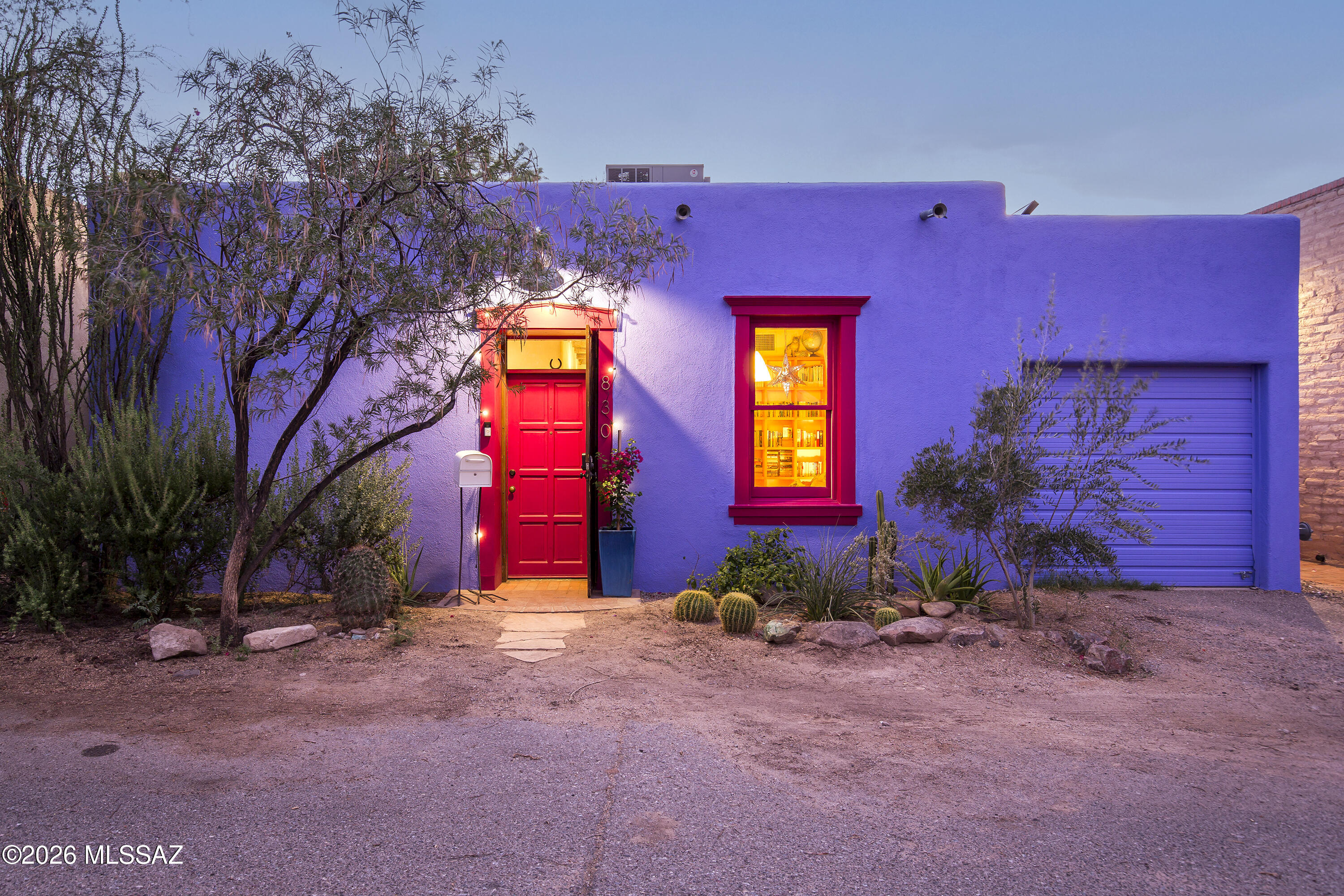 Been dreaming of a 26'' thick rammed earth construction home on Tucson's most photographed colorful street?  Don't miss this beauty!  Brick floors & salvaged wood floors, saguaro rib & viga ceilings.  The walls are hand troweled with natural American Clay--sustainable and repairable integrated color with very subtle mica. Outdoor spaces provide peaceful privacy, with mature mesquites and fully fenced pet-friendly small backyard that wraps around to protected patio. All of the charm you can imagine, vintage doors, niches and a sweet wood-burning fireplace, unique custom steel interior shutters.   It's a colorful street, and this home is periwinkle with magenta trim, with evening shift to deep purple. One car attached garage. A few blocks to EXO, the Coronet... walkscore 84!